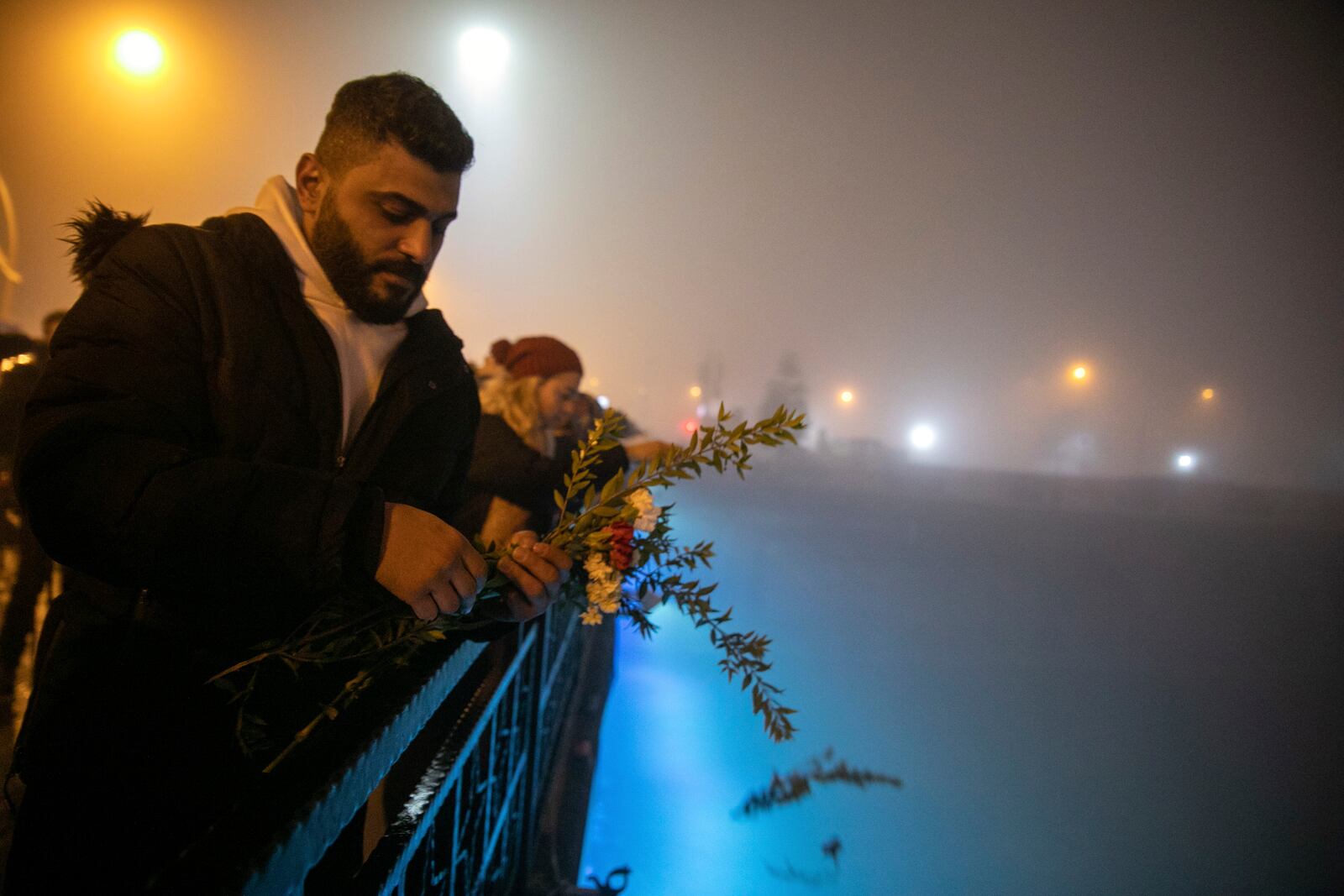 FILE - People toss carnations into the Orontes River as they mark the one-year anniversary of the country's catastrophic earthquake, in the city of Antakya, southern Turkey, Tuesday, Feb. 6, 2024. (AP Photo/Metin Yoksu, File)