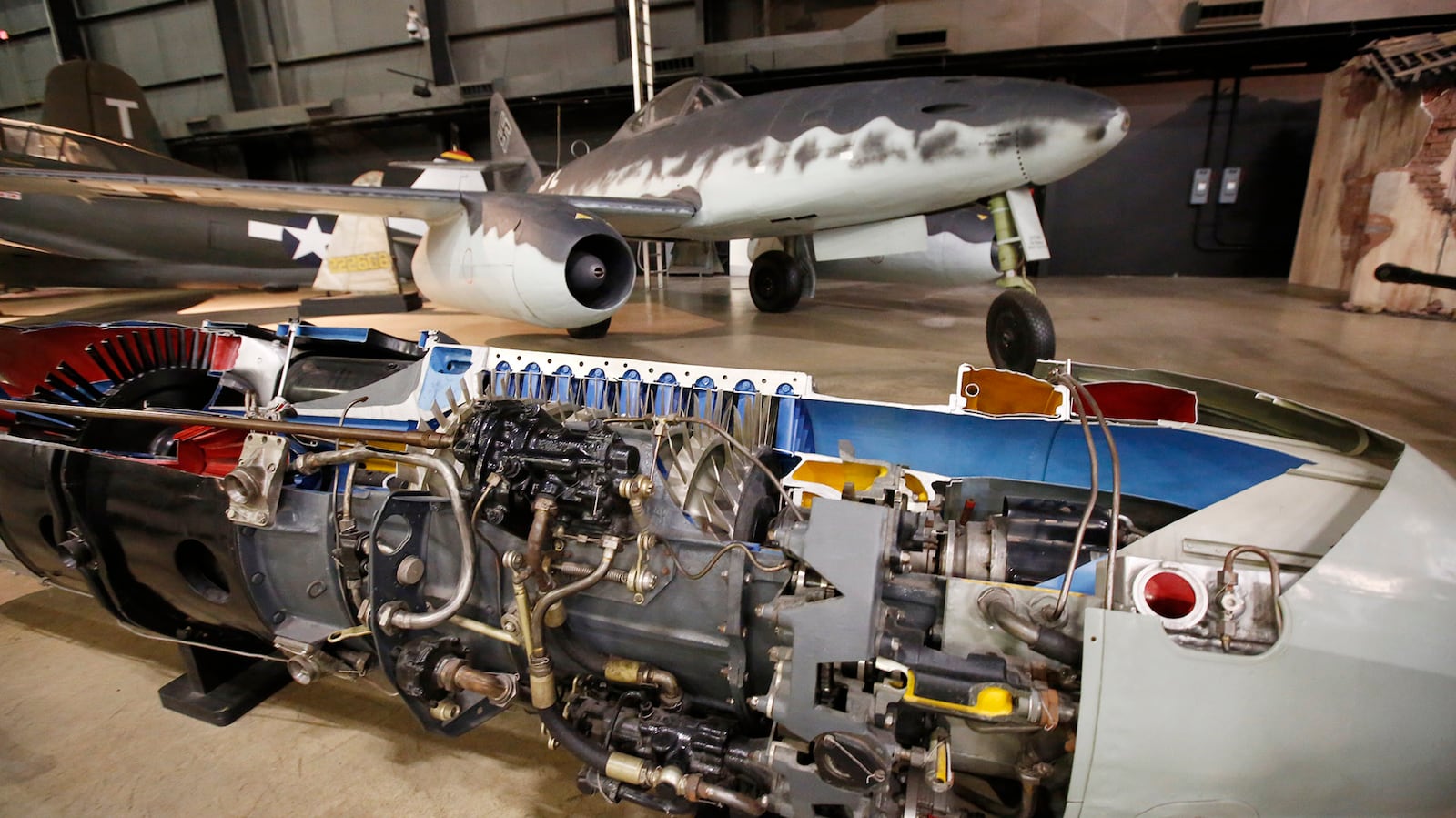 Cutaway display or the Junkers Jumo 004 turbojet engine that powered the first jet fighter, the twin-engine Messerschmitt Me 262, in the background, for the Germans in WW II.  The National Museum of the United States Air Force will soon open the Memphis Belle exhibit, a crown jewel of the World War II Galllery.   TY GREENLEES / STAFF