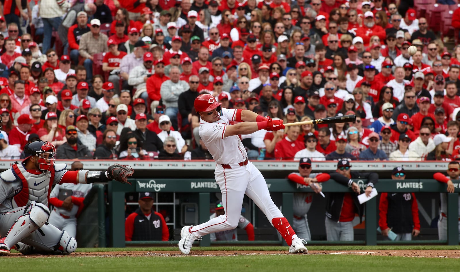 Spencer Steer, of the Reds, drives in the first run of the game in the second inning against the Nationals on Opening Day on Thursday, March 28, 2024, at Great American Ball Park in Cincinnati. David Jablonski/Staff