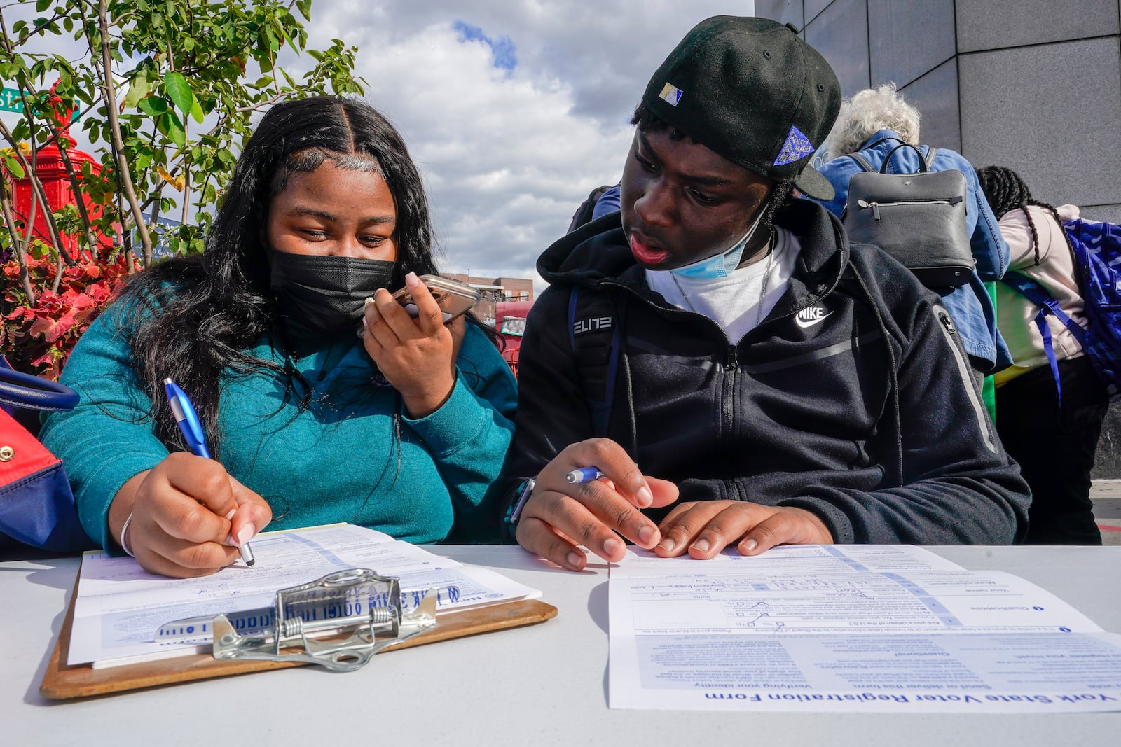 Residents of the Flatbush neighborhood of the Brooklyn borough of New York register to vote at a voter registration event, Wednesday, Sept. 29, 2021. (AP Photo/Mary Altaffer)