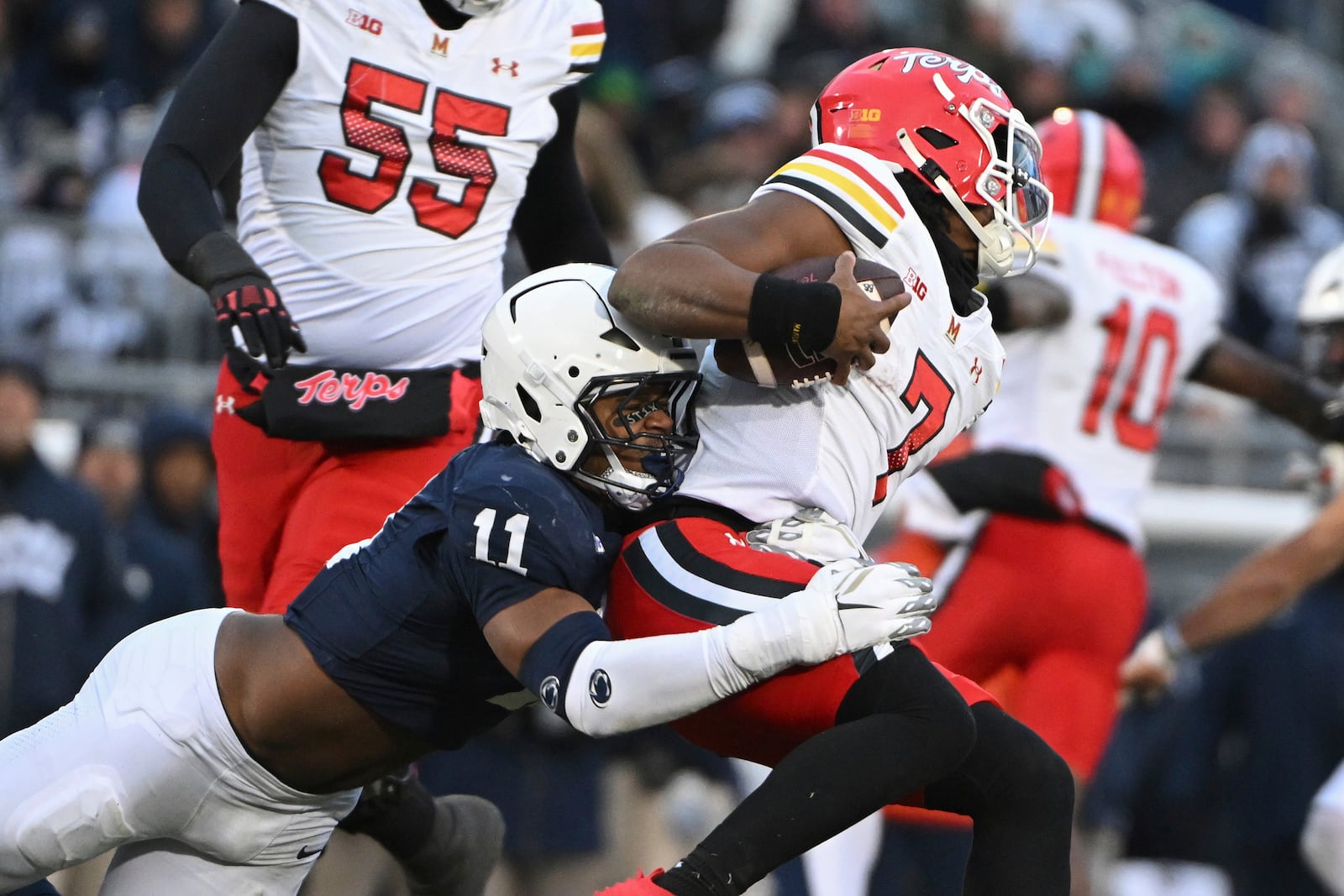 Penn State defensive end Abdul Carter (11) sacks Maryland quarterback MJ Morris (7) during the first quarter of an NCAA college football game, Saturday, Nov. 30, 2024, in State College, Pa. (AP Photo/Barry Reeger)