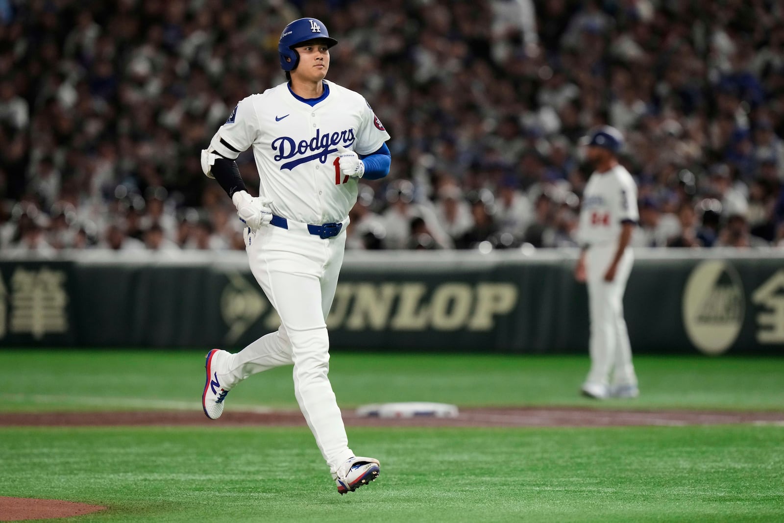 Los Angeles Dodgers' Shohei Ohtani jogs to the dugout after flying out to left in the first inning of an MLB Tokyo Series baseball game against the Chicago Cubs in Tokyo, Japan, Wednesday, March 19, 2025. (AP Photo/Eugene Hoshiko)