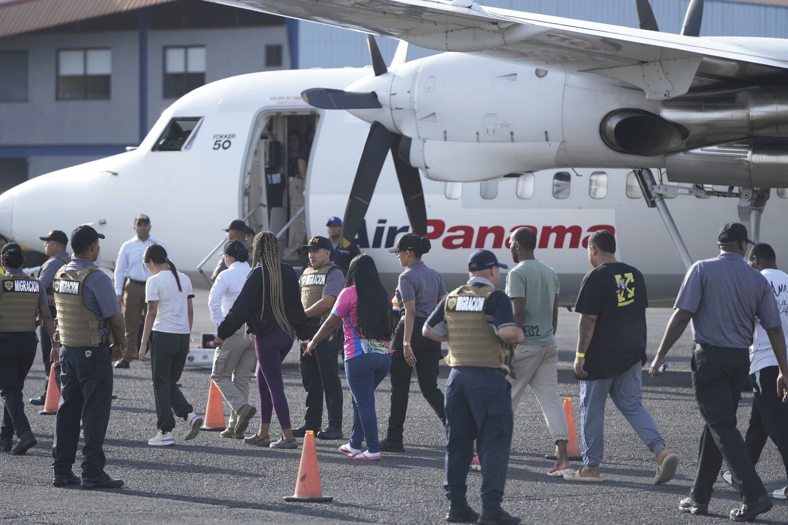 People arrive to board a repatriation flight bound for Colombia at Albrook Airport in Panama City, Monday, Feb. 3, 2025. (AP Photo/Mark Schiefelbein, Pool)