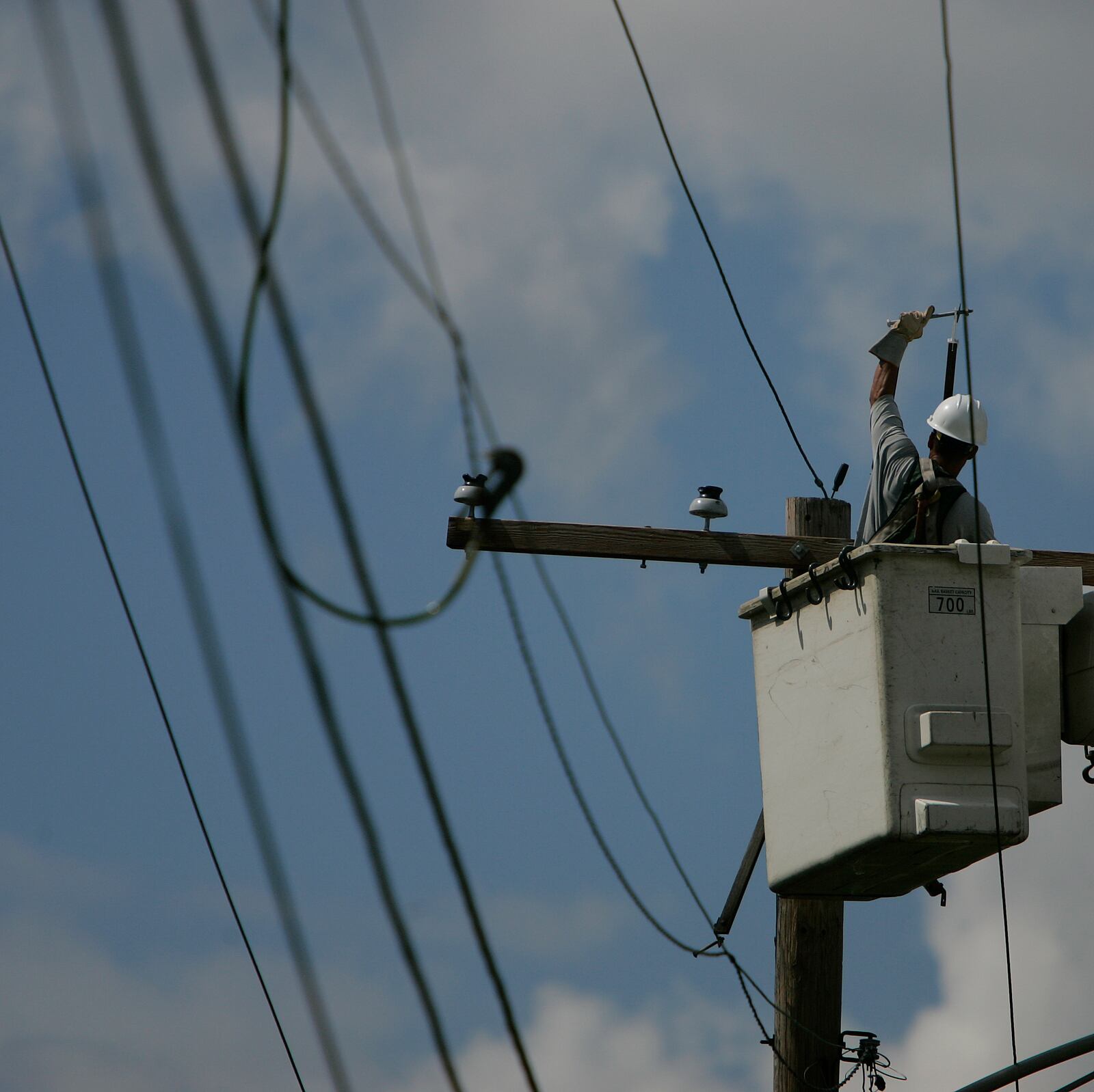 DP&L troubleman, Thong Vongsy, works on downed lines on Dayton-Liberty Road Tuesday September 16th in Dayton. Jim Noelker/Dayton Daily News