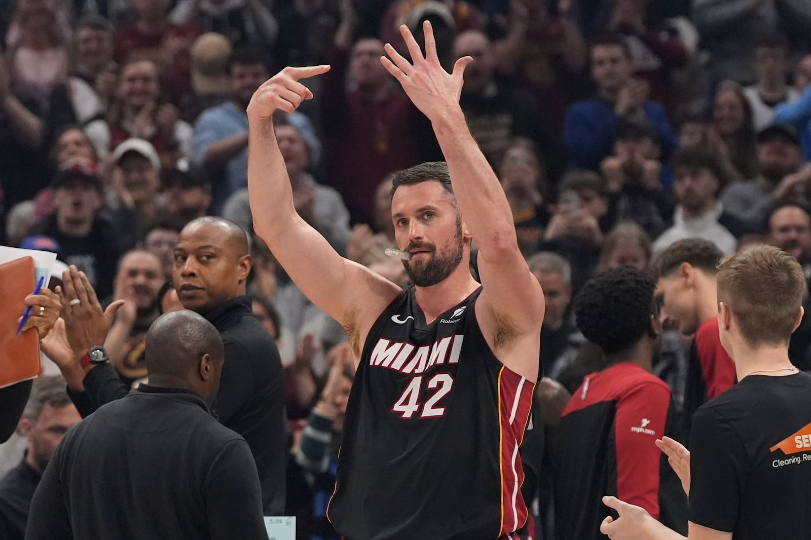 Miami Heat forward Kevin Love (42) gestures to the crowd after a video tribute and introduction in the first half of an NBA basketball game between the Miami Heat and the Cleveland Cavaliers Wednesday, March 5, 2025, in Cleveland. (AP Photo/Sue Ogrocki)