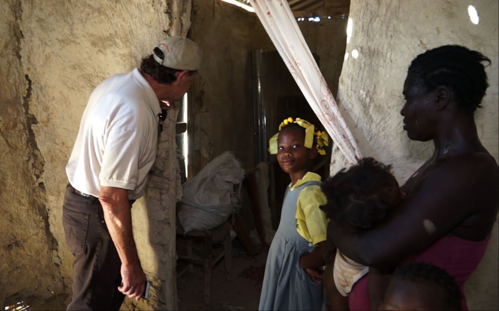 Hope For Haitians remains committed to helping people escape inhumane living conditions for secure and permanent housing. Co-Chairman Ben Scott of Piqua looks inside the crumbling structure where a mother and her three children live in Savann Kabrit, Haiti. Hope For Haitians is working with Food For The Poor to build an additional 50 homes in the remote area of Savann Kabrit, which is east of Port-au-Prince, near  the border of the Dominican Republic. (Photo/Food For The Poor)