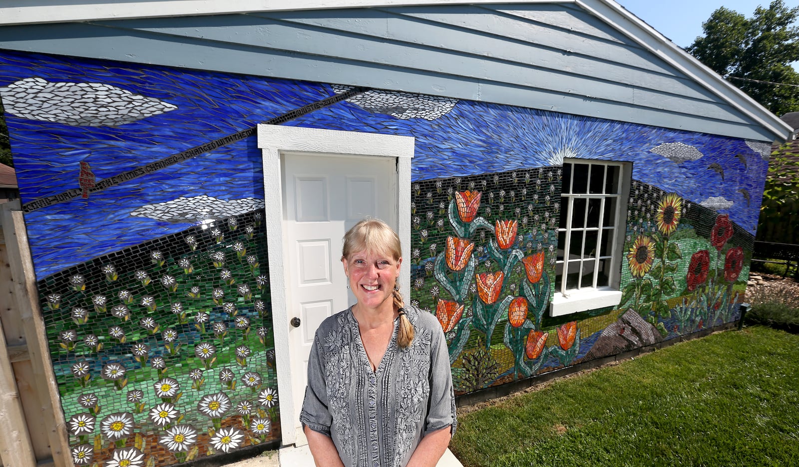 Guustie Alvarado, a Tipp City artist, spent a year creating “Covid Wall,” a glass mosaic on her garage. The artwork is filled with images meaningful to her life experience. Alvarado will be a presenter at PechaKucha Night Dayton on Wednesday, Sept. 1. The event will be held downtown at the Levitt Pavilion and begins at 7:30 p.m. LISA POWELL / STAFF