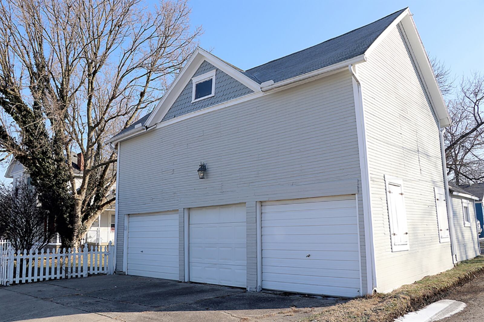 A carriage house has 3 overhead doors plus loft storage and office space. Extra parking is off the side street to the overhead doors of the carriage house. CONTRIBUTED PHOTO BY KATHY TYLER