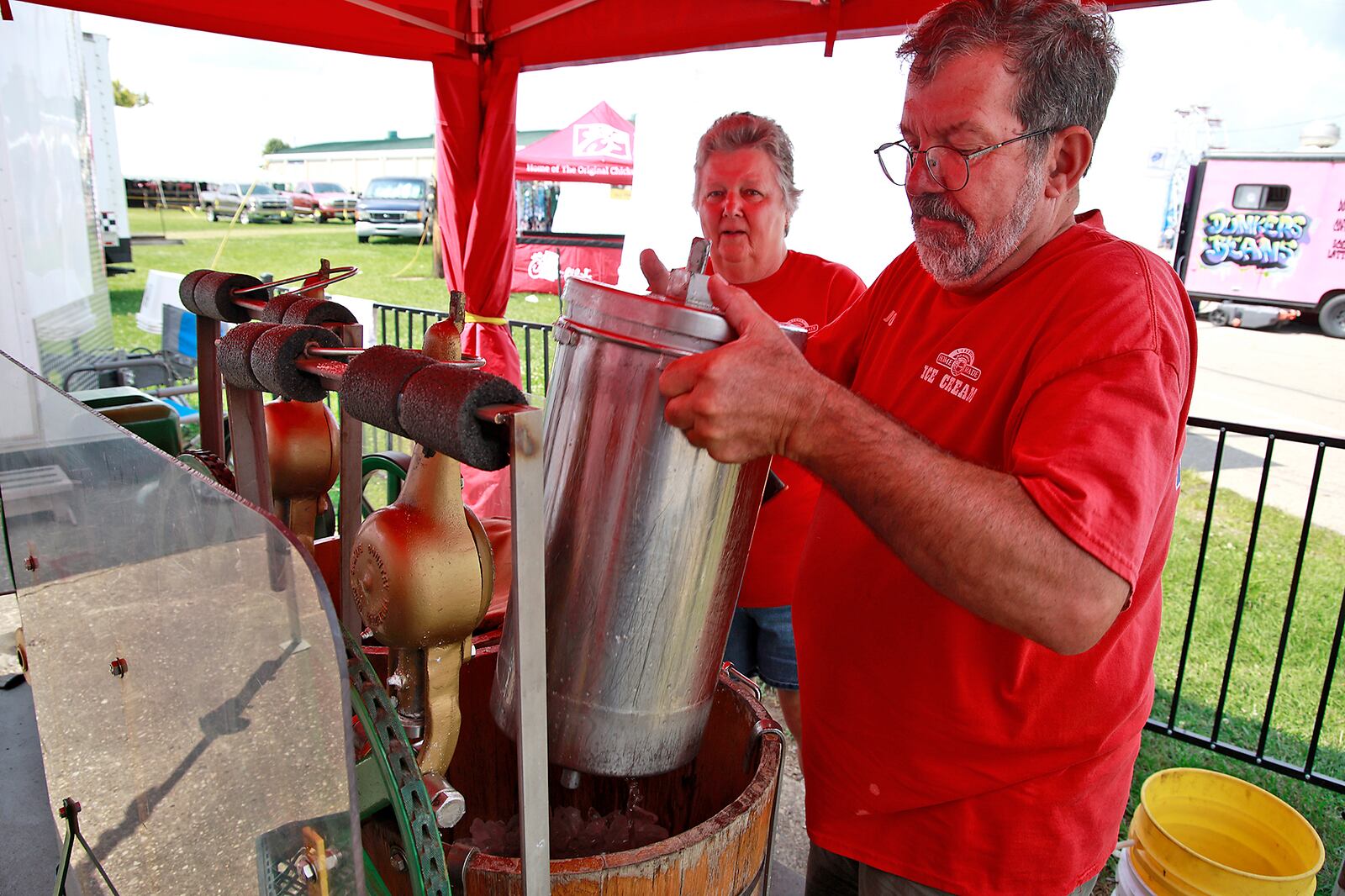 Rhonda and Joe Kramer at work making ice cream at Ullery's Homemade Ice Cream at the Clark County Fair Wednesday, July 24, 2024. BILL LACKEY/STAFF