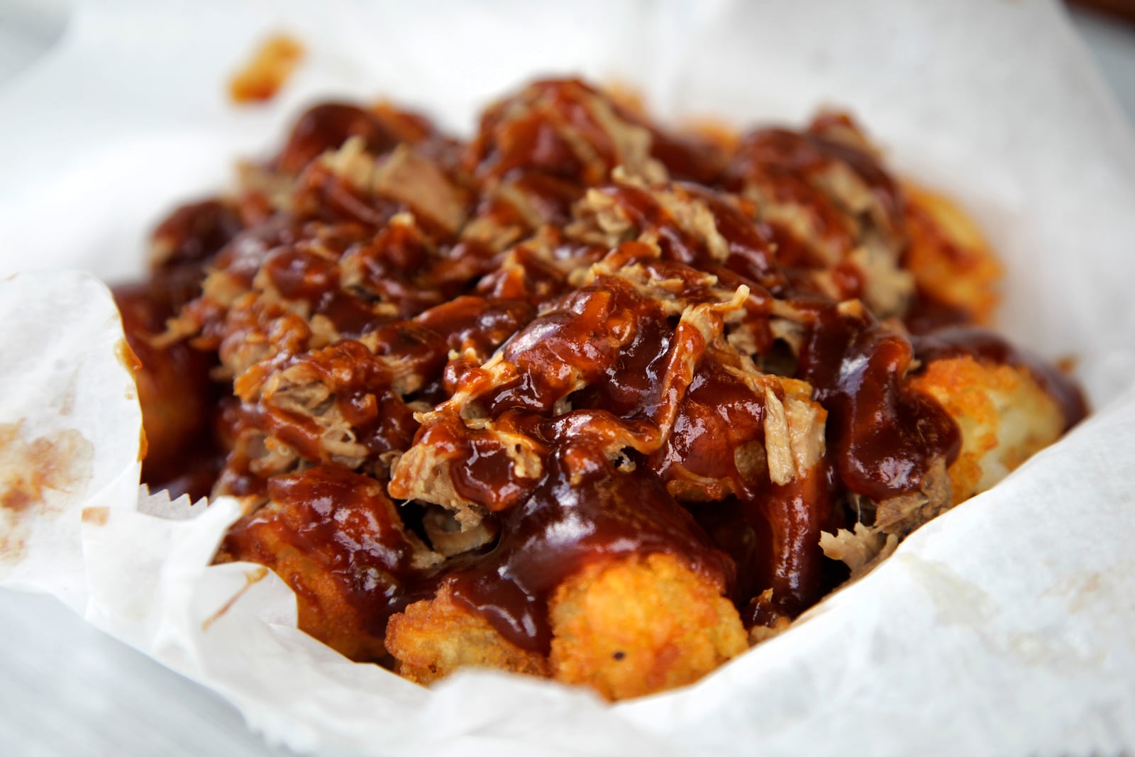 Hillbilly Tots at Underdogs Mobile are topped with smoked pulled pork and BBQ sauce.  LISA POWELL / STAFF