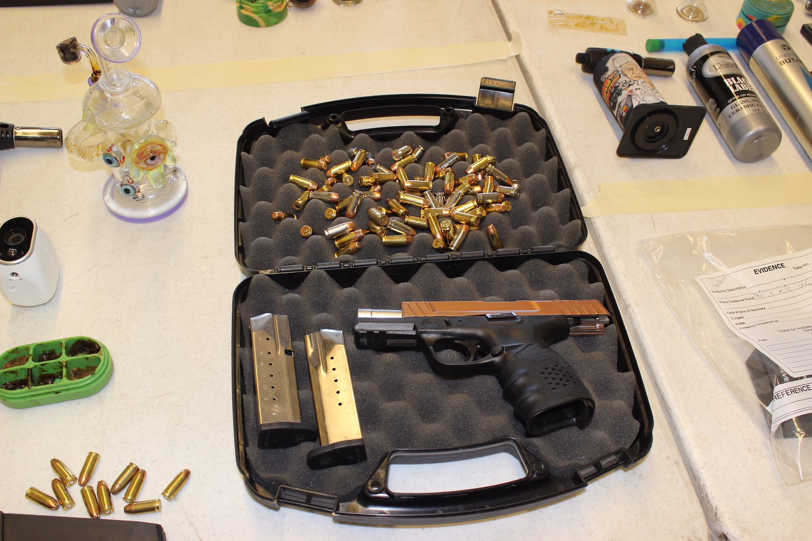 This handgun and items used in the consumption of drugs were among the items German Twp., Clark County, police seized in a raid this week. (Darrin Pope/Staff)