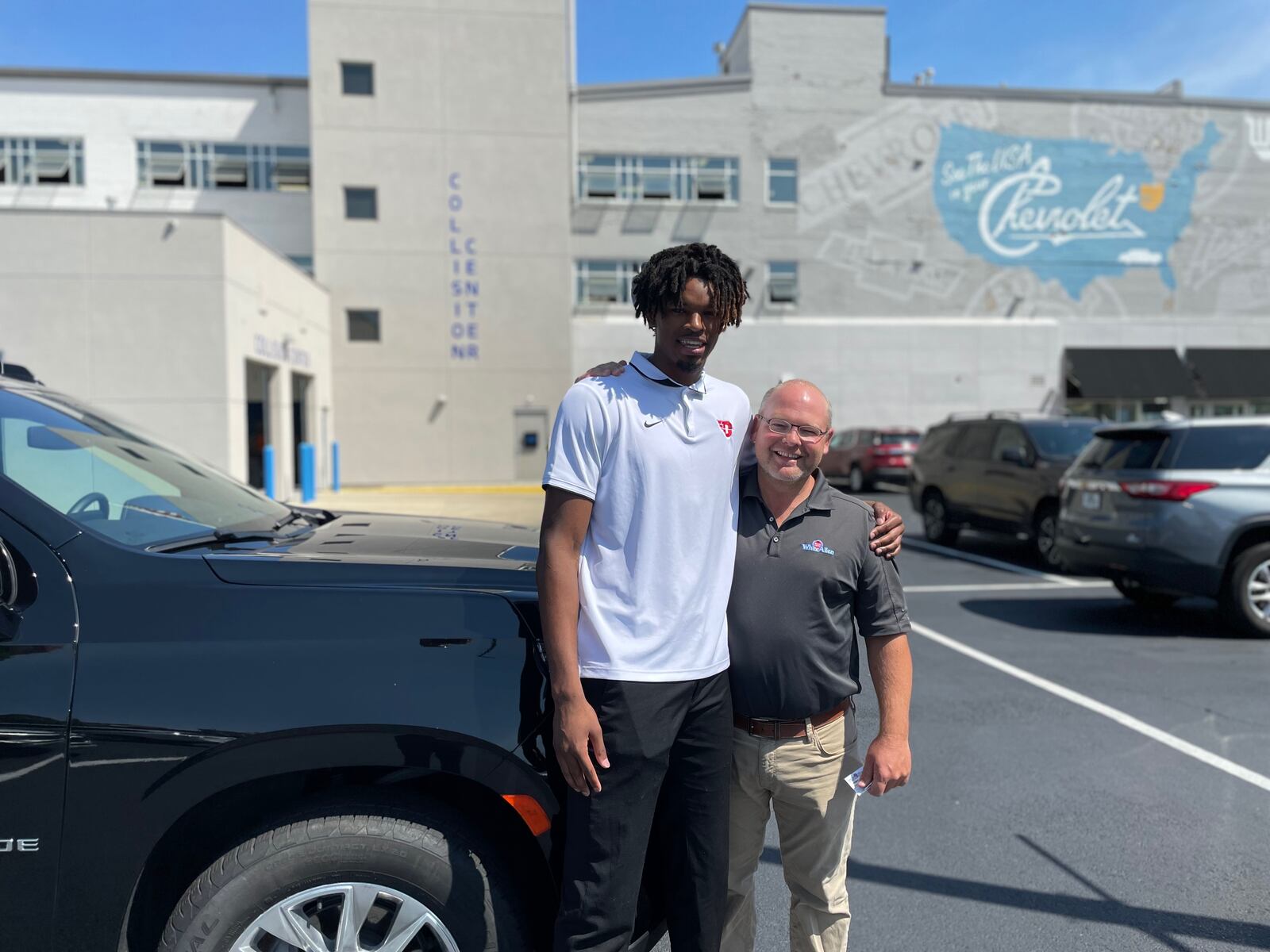 DaRon Holmes II poses for a photo with Tim White Jr., President of of White-Allen, on Friday, July 15, 2022, after receiving the keys to a Chevy Tahoe in Dayton. Photo courtesy of Matt Farrell