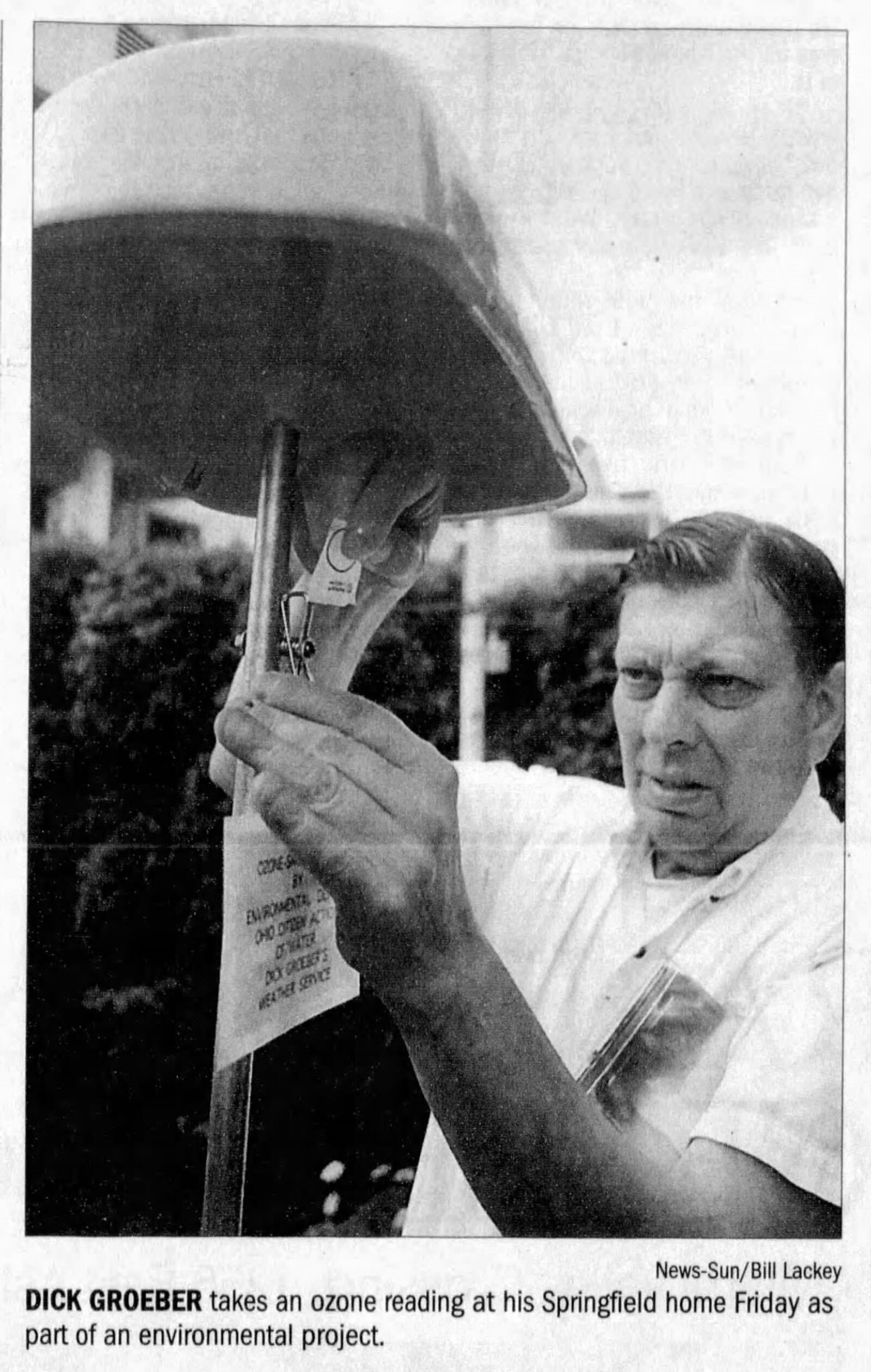 Dick Groeber takes an ozone reading at his Springfield home as part of an environmental project in 2001. NEWS-SUN BILL LACKEY