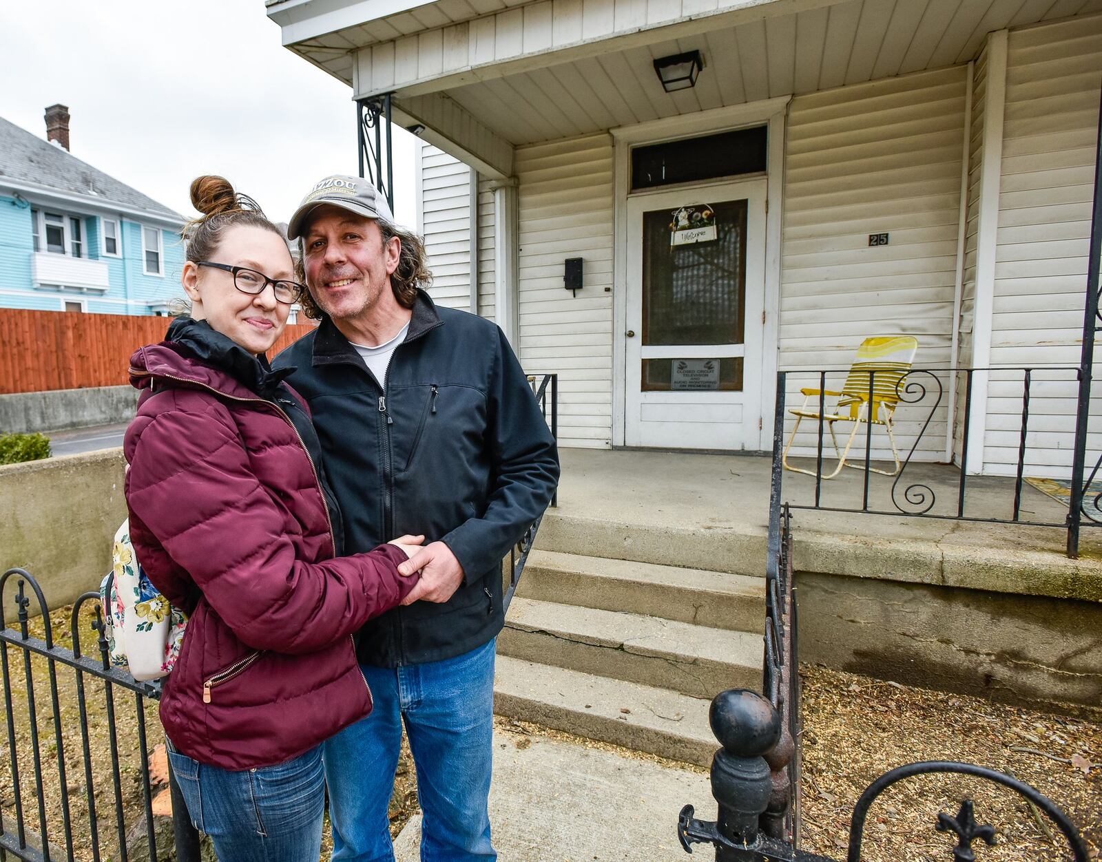 Kimberly Bley and Randy Slater stand in front of a house at 25 South C Street in Hamilton. Bley, who recently purchased the house, found a well nearly 25 feet deep underneath the kitchen floor while renovating. NICK GRAHAM/STAFF