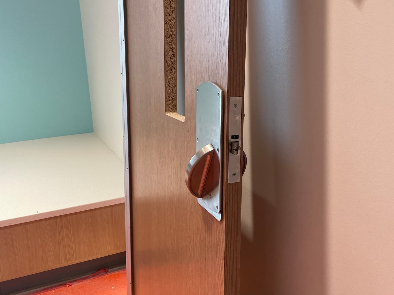 A door at Dayton Children's Mathile Center for Mental Health and Wellness with an anti-ligature handle on it that is specifically designed to prevent patients from tying something to the door to hurt themselves. SAM WILDOW/STAFF