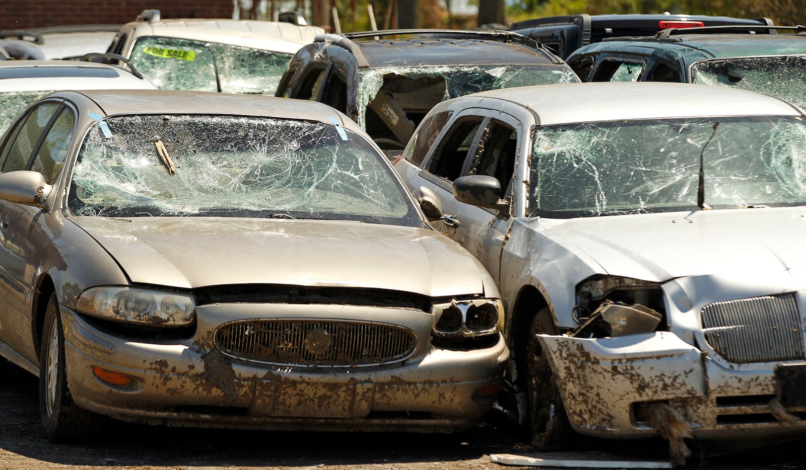 Zo's Auto Sales lost nearly 40 cars and sustained heavy damage to its building on North Dixie Drive  in Harrison Twp. A few heavily damaged cars remained on Tuesday morning. Two weeks have passed since a tornado ripped through the area causing catastrophic damage to homes and businesses in the area.  TY GREENLEES / STAFF