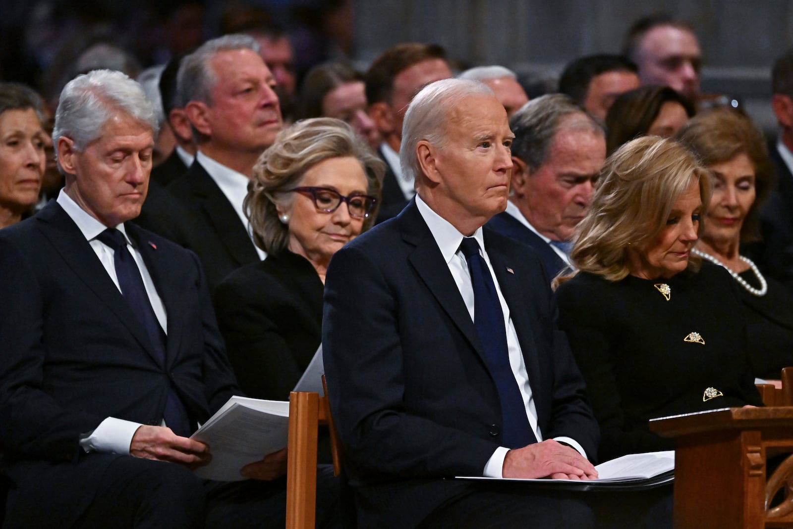 Marilyn Quayle, from third row left, former Vice President Al Gore, from second row left, former President Bill Clinton, former Secretary of State Hillary Clinton, former President George W. Bush and his wife former first lady Laura Bush, and from front row left, President Joe Biden and first lady Jill Biden listen during a state funeral for former President Jimmy Carter at the National Cathedral, Thursday, Jan. 9, 2025, in Washington. Looking on in background at seco(Ricky Carioti/The Washington Post via AP, Pool)