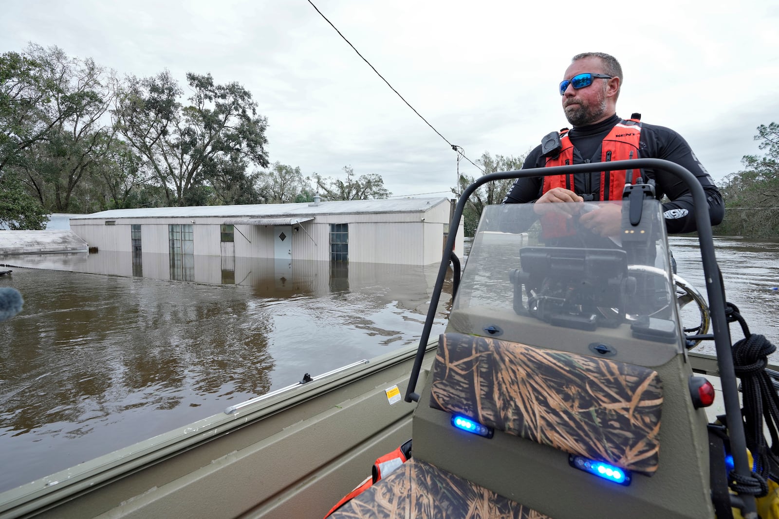 Hillsborough County Sheriff's Master Deputy Robert Unger checks out flooded home from the effects of Hurricane Milton along the Alafia river Friday, Oct. 11, 2024, in Lithia, Fla. (AP Photo/Chris O'Meara)