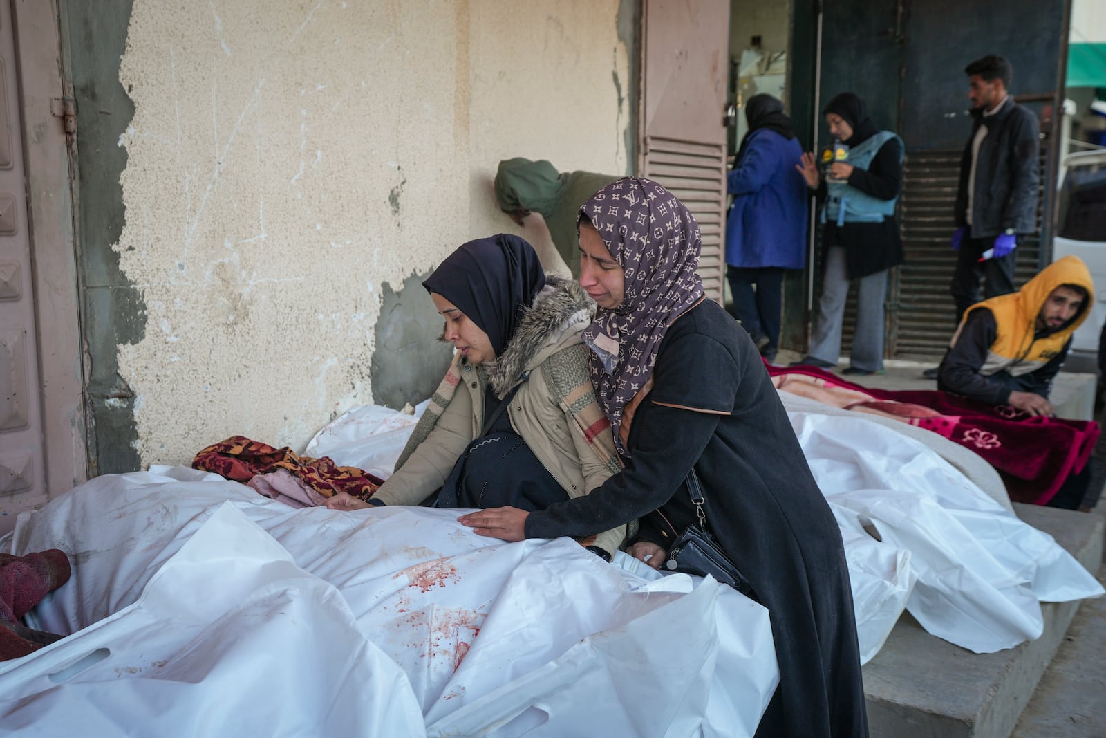 Relatives mourn over the bodies of victims of overnight Israeli army strikes at multiple locations in central Gaza Strip, at Al-Aqsa Martyrs Hospital in Deir al-Balah, Friday, Jan. 3, 2025. According to Al-Aqsa Martyrs Hospital, 30 people, including 10 women and 7 children, were killed in several attacks overnight in central Gaza. (AP Photo/Abdel Kareem Hana)