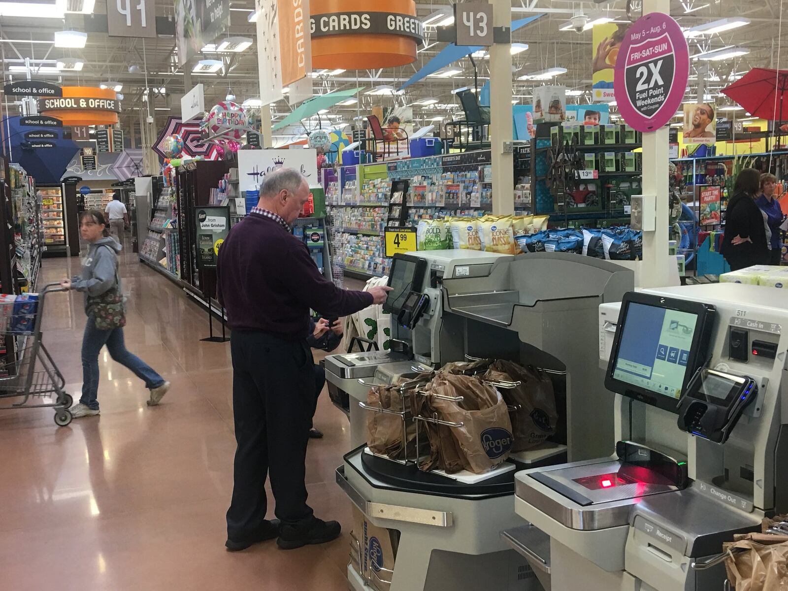 A customer pays for his purchase at the self-checkout lanes in the new Cornerstone of Centerville store. KARA DRISCOLL/STAFF