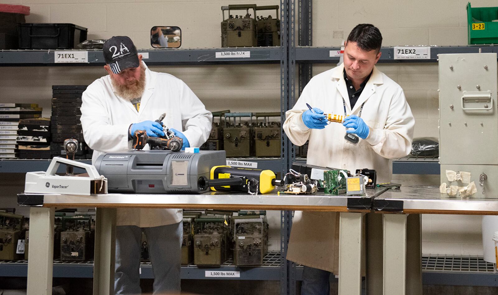 Charlie Mitchell (left) and Seth Walton of the 88th Civil Engineer Group inspect and remove radioactive components from pieces of equipment at the Air Force Radioactive Recycling and Disposal facility on Wright-Patterson Air Force Base. U.S. AIR FORCE PHOTO/JAIMA FOGG