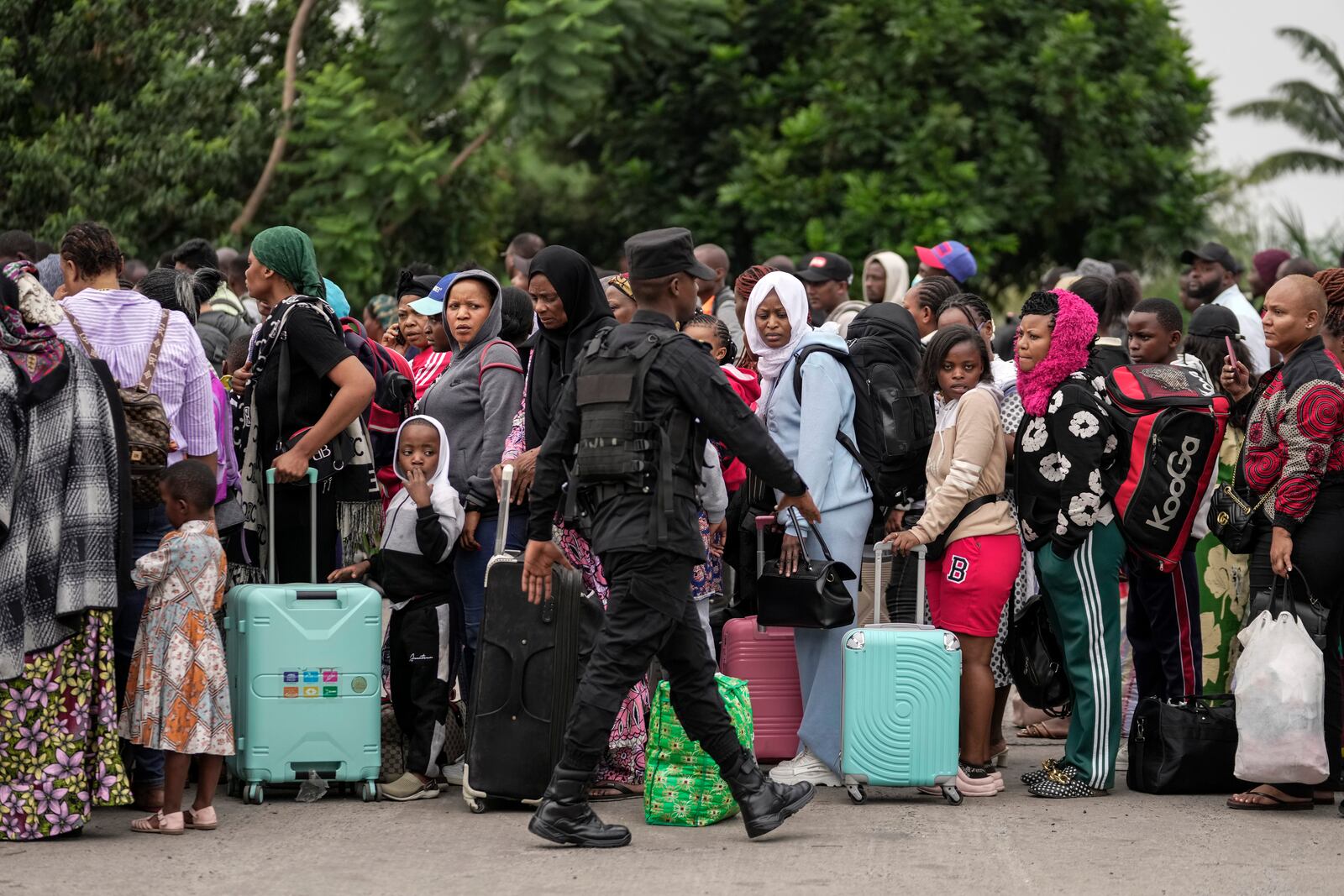 Rwanda security officials check people crossing from Congo in Gisenyi, Rwanda Rwanda, Wednesday, Jan. 29, 2025, following M23 rebels' advances into eastern Congo's capital Goma. (AP Photo/Brian Inganga)