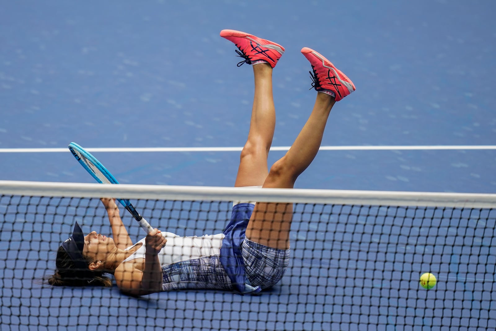 Tsvetana Pironkova, of Bulgaria, falls to the court during a match against Serena Williams, of the United States, during the quarterfinals of the US Open tennis championships, Wednesday, Sept. 9, 2020, in New York. (AP Photo/Seth Wenig)