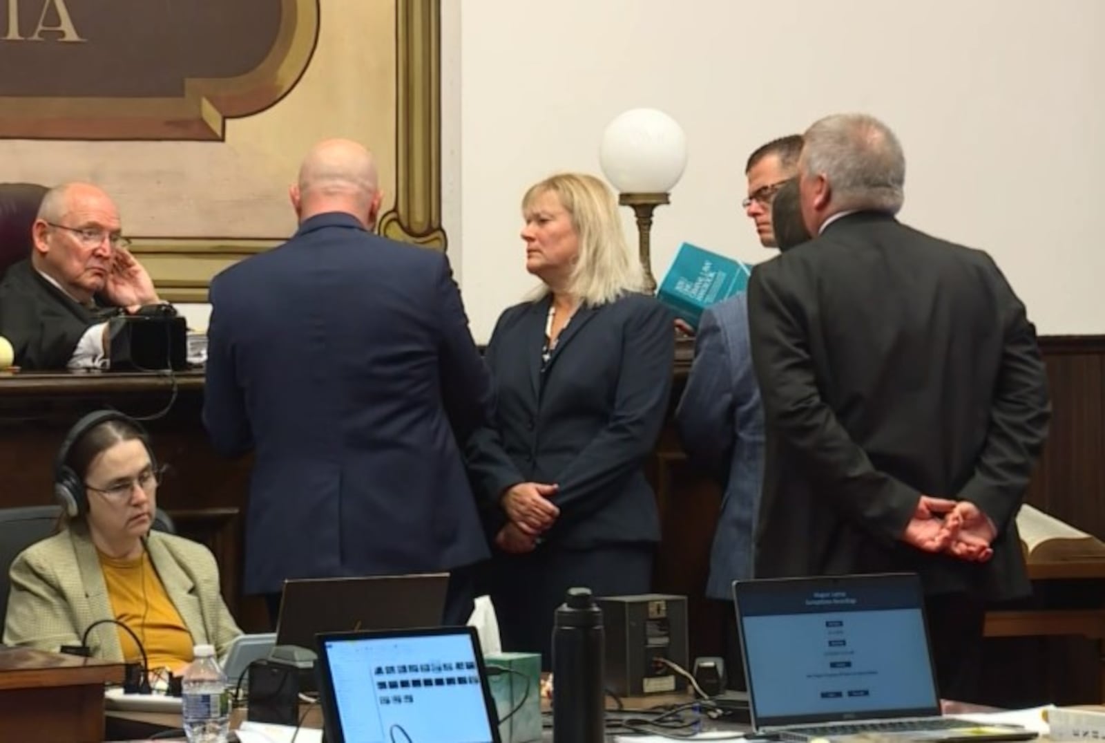 Prosecutor Angela Canepa, center, and members of the prosecution and defense teams, talk with Judge Randy Deering during the Pike County, Ohio murder trial of George Wagner IV on Oct. 18, 2022. Wagner is accused of killing eight members of a family in Pike County in 2016. WCPO/CONTRIBUTED