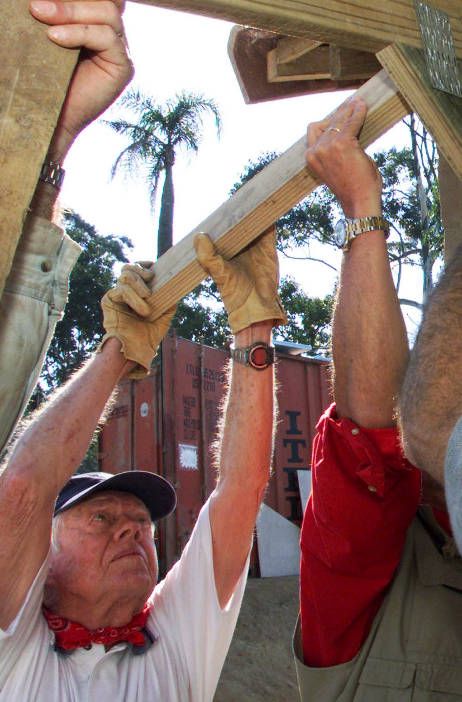 FILE - Former U.S. President Jimmy Carter helps in the contruction of a low-income housing project in Durban, South Africa, June 6, 2002. Carter was among 4,500 volunteers, organized by Habitat for Humanity, building 100 homes in the coastal city during the week. (AP Photo/Themba Hadebe, File)