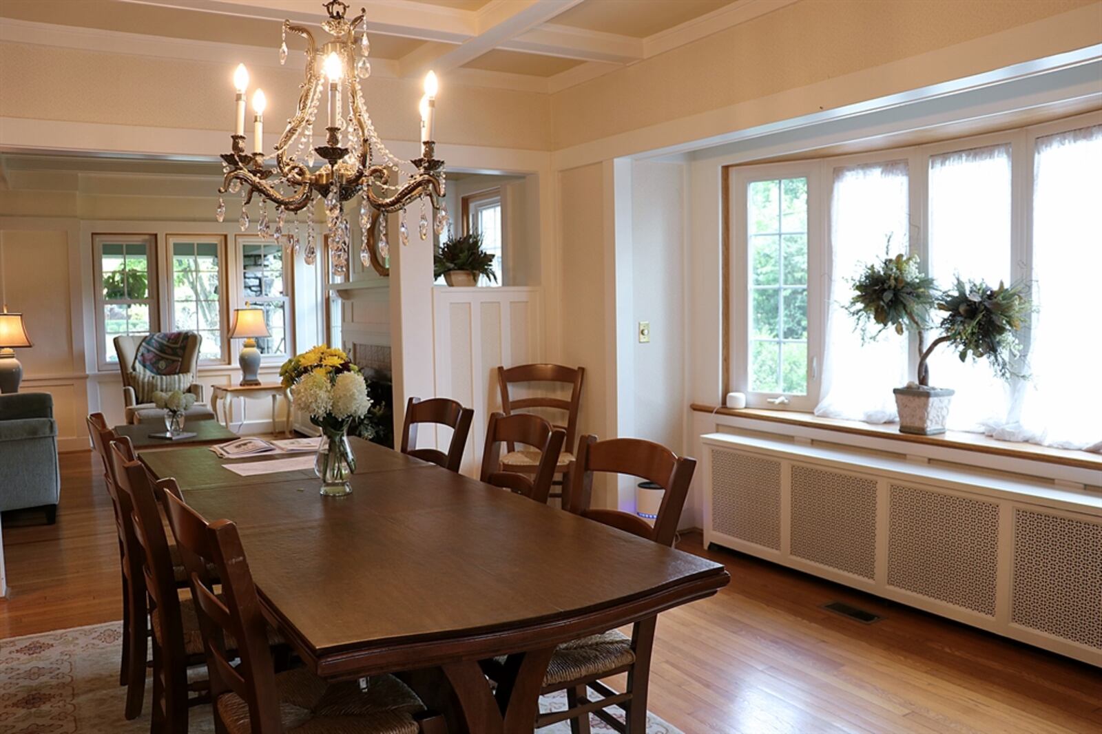 A large bay window fills the dining room with natural light and the picture-frame wood flooring brings attention to the dining area.