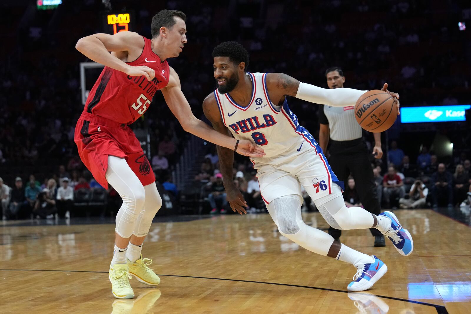 Philadelphia 76ers forward Paul George (8) drives to the basket as Miami Heat forward Duncan Robinson (55) defends during the first half of an NBA basketball game, Monday, Nov. 18, 2024, in Miami. (AP Photo/Lynne Sladky)