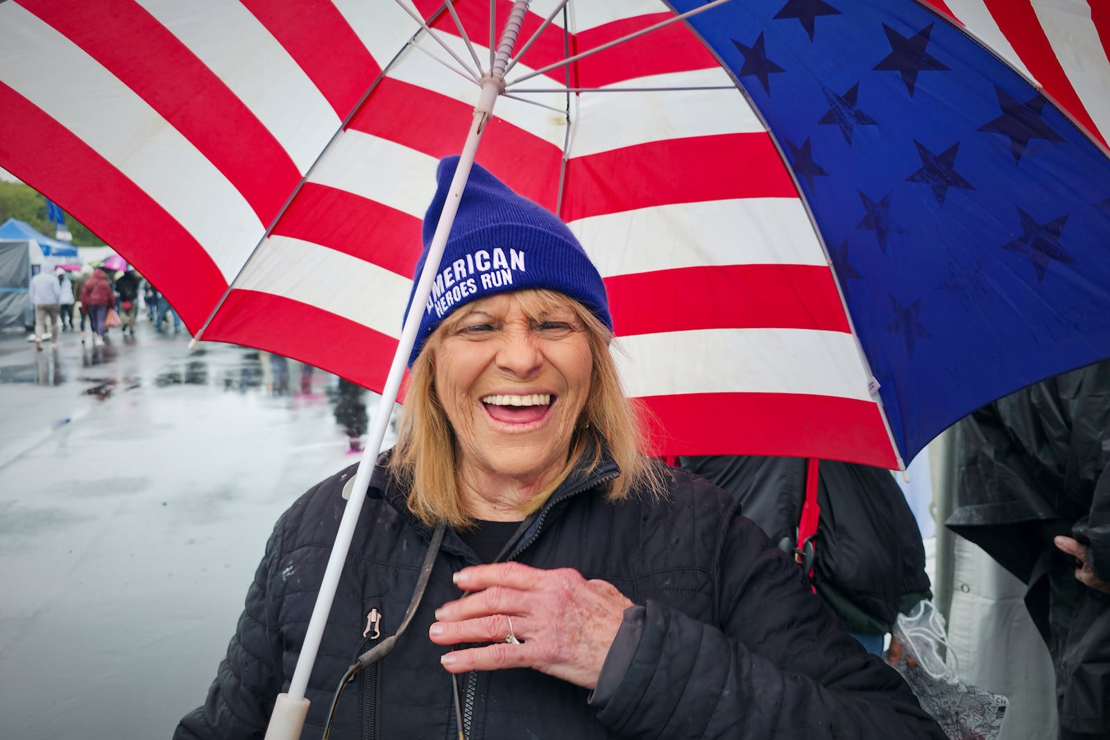 Sharon Kerson, 83, smiles while gathering with fellow runners at the Lifestyle Expo at Dodger Stadium, Friday, March 14, 2025 in Los Angeles. (AP Photo/Damian Dovarganes)