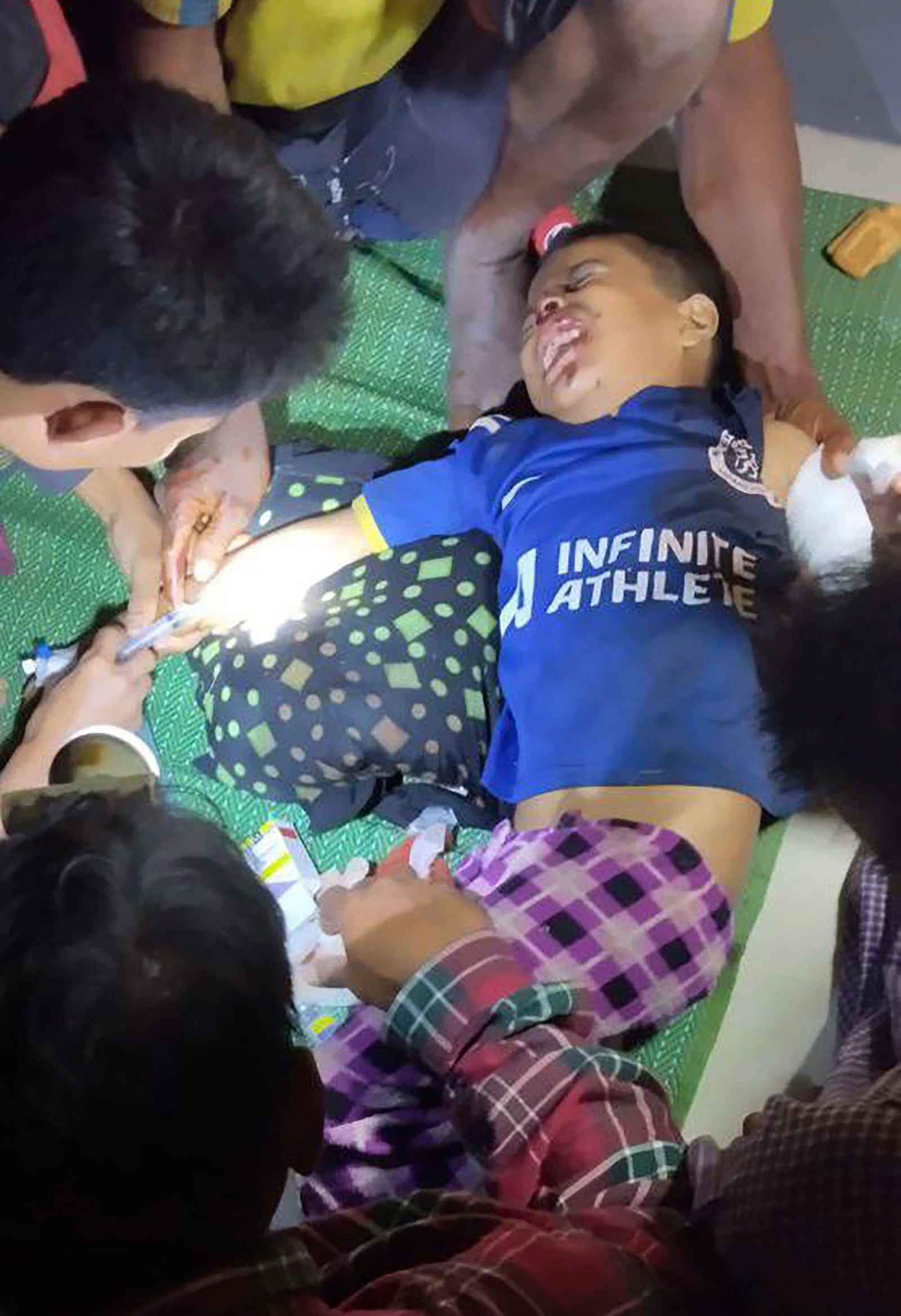 This handout photo provided by the Arakan Army shows a child being treated for injuries after what it said was an airstrike by the ruling military in Kyauk Ni Maw village, in Ramree township, also pronounced Yanbye, in Rakhine state, Myanmar, Wednesday, Jan.8, 2025. (The Arakan Army via AP)