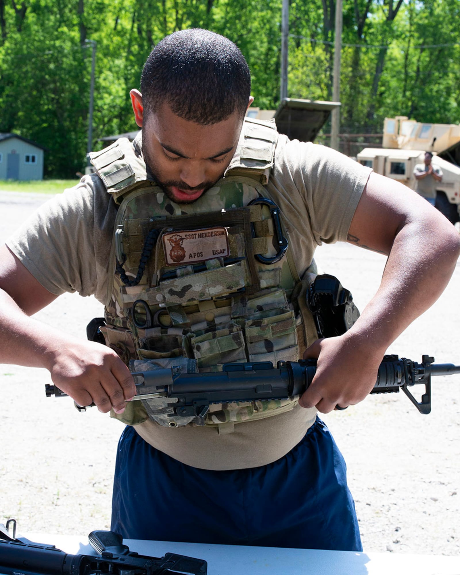 Staff Sgt. Ross Henderson, 88th Security Forces Squadron, disassembles an M4 rifle during the National Police Week Defenders Challenge on May 16 at Wright-Patterson Air Force Base. Teams from across the base tested their mental and physical skills while competing in the timed event. U.S. AIR FORCE PHOTO/JAIMA FOGG