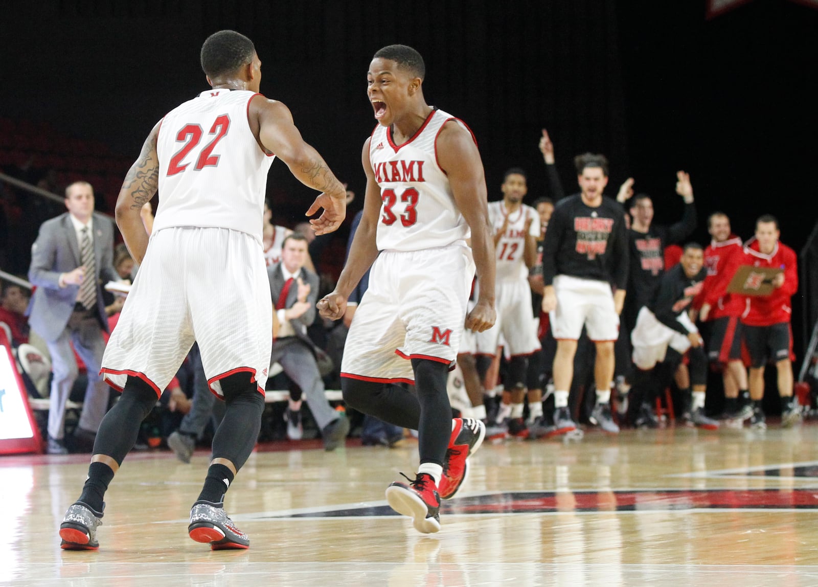 Miami's Willie Moore, left, and Eric Washington celebrate a basket against Dayton on Wednesday, Dec. 3, 2014, at Millett Hall in Oxford.