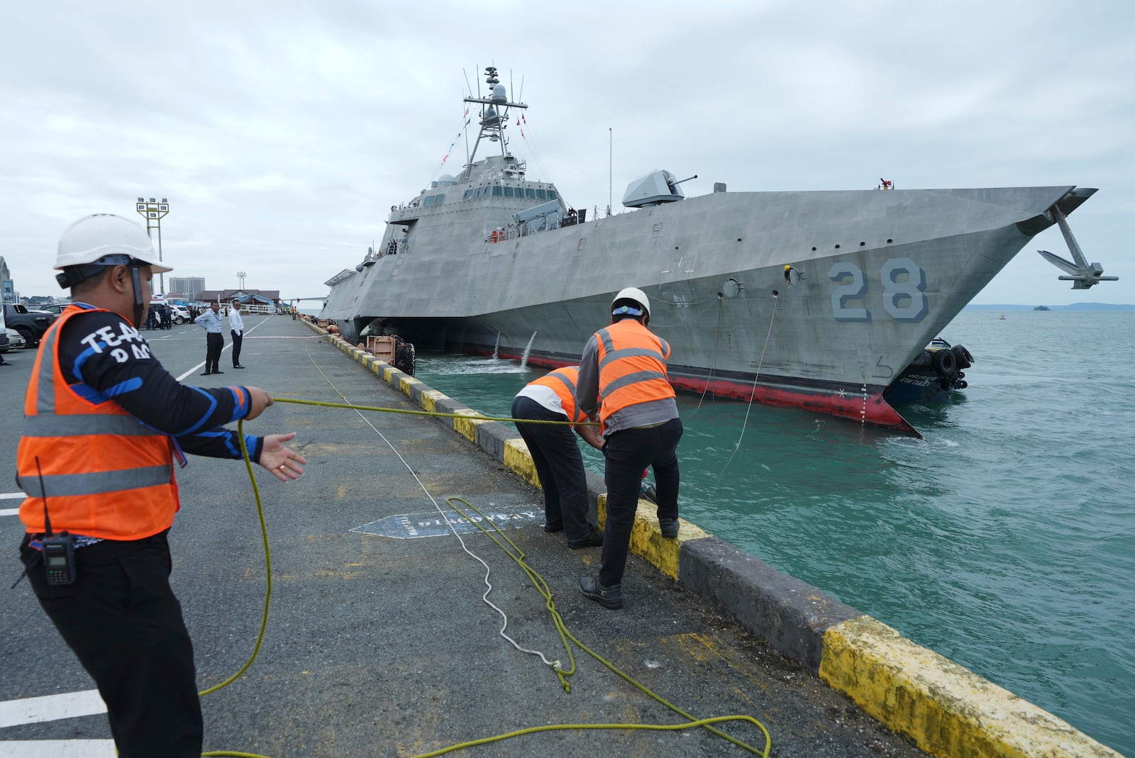 Cambodian port members tie USS Savannah as it arrives for a port call at Sihanoukville port, Cambodia, Monday, Dec. 16, 2024. (AP Photo/Heng Sinith)