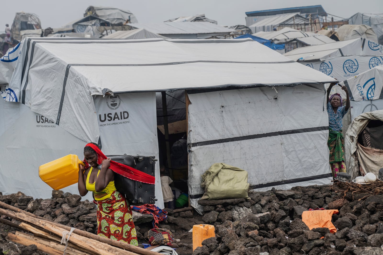 People who were displaced by the fighting between M23 rebels and government soldiers leave their camp following an instruction by M23 rebels in Goma, Democratic Republic of the Congo, Tuesday, Feb. 11, 2025. (AP Photo/Moses Sawasawa)