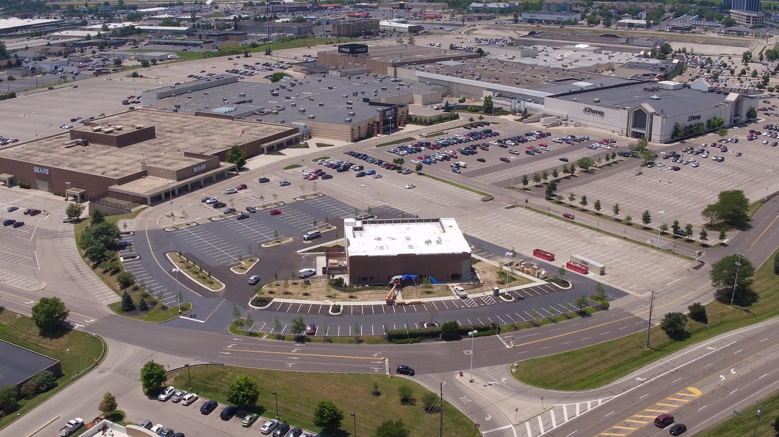 Construction of a new Outback Steakhouse at the Dayton Mall has transformed the former Sears Automotive Center in to a modern looking building that will also include retail space.   TY GREENLEES / STAFF