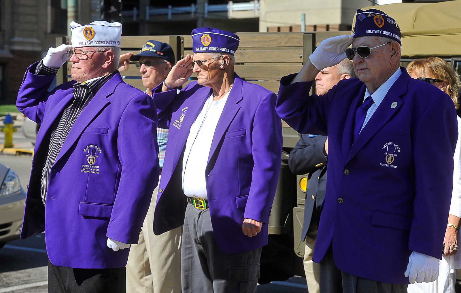 Members of the Military Order of the Purple Heart salute during the National Purple Heart Day Ceremony Tuesday at the Purple Heart monument beside the Springfield Post Office. Staff photo by Bill Lackey