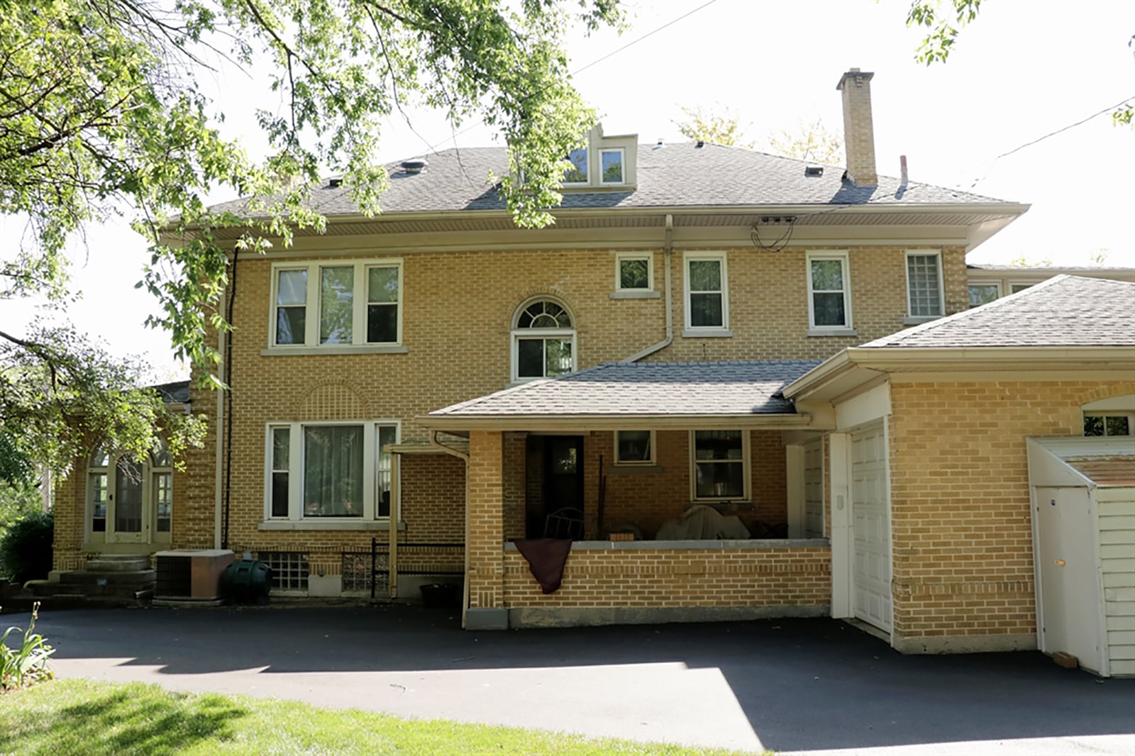 A 2-car garage is at the back of the house and has a double overhead door on one side and two single overhead doors on the opposite to allow for drive-through access. A covered porch is off the back of the house. CONTRIBUTED PHOTO BY KATHY TYLER