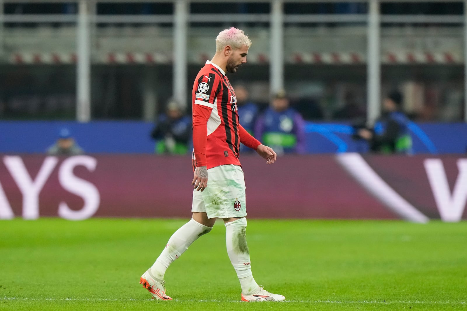 AC Milan's Theo Hernandez leaves the pitch after being sent off by Referee Szymon Marciniak of Poland after his second yellow card during Champions League, playoff second leg soccer match between AC Milan and Feyenoord, at the San Siro stadium in Milan, Italy, Tuesday, Feb.18, 2025. (AP Photo/Luca Bruno)