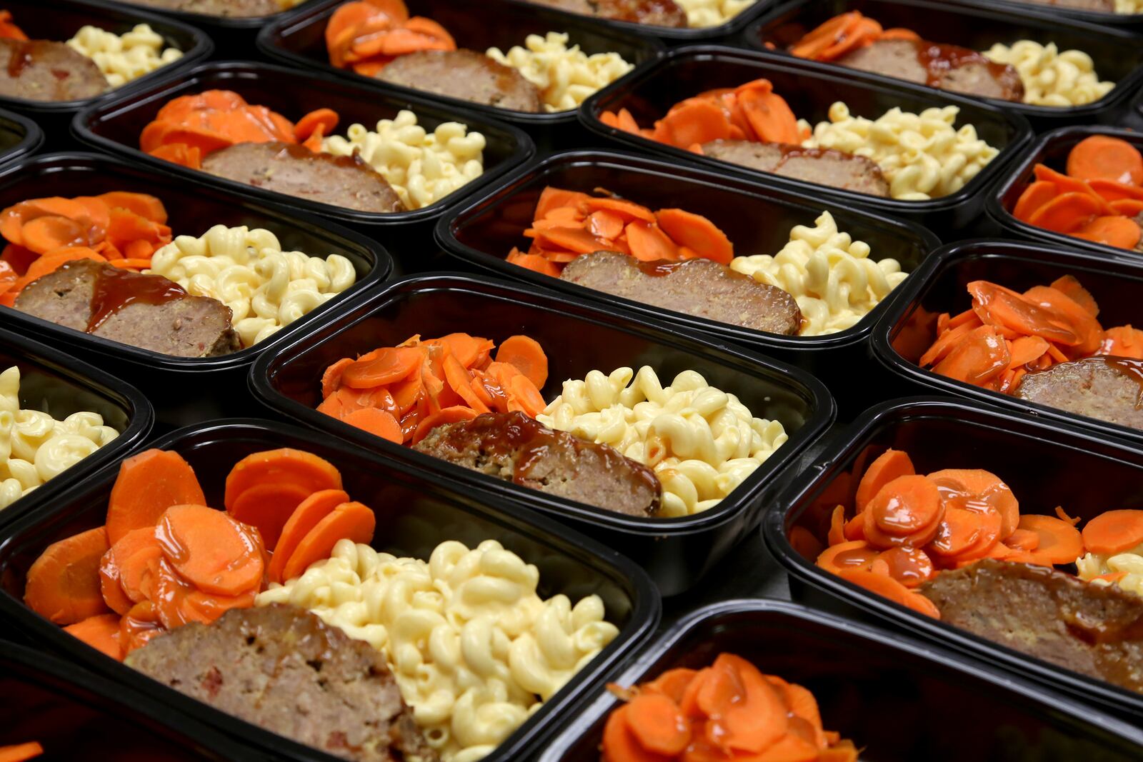 Meat loaf with macaroni and cheese and cinnamon dolce carrots are one of the popular meals provided by Pink Ribbon Girls to patients with breast or gynecological cancers. Marshall Bartley, the executive chef, and his five-person team prep and cook 1,800 to 2,000 meals each week for delivery. LISA POWELL / STAFF