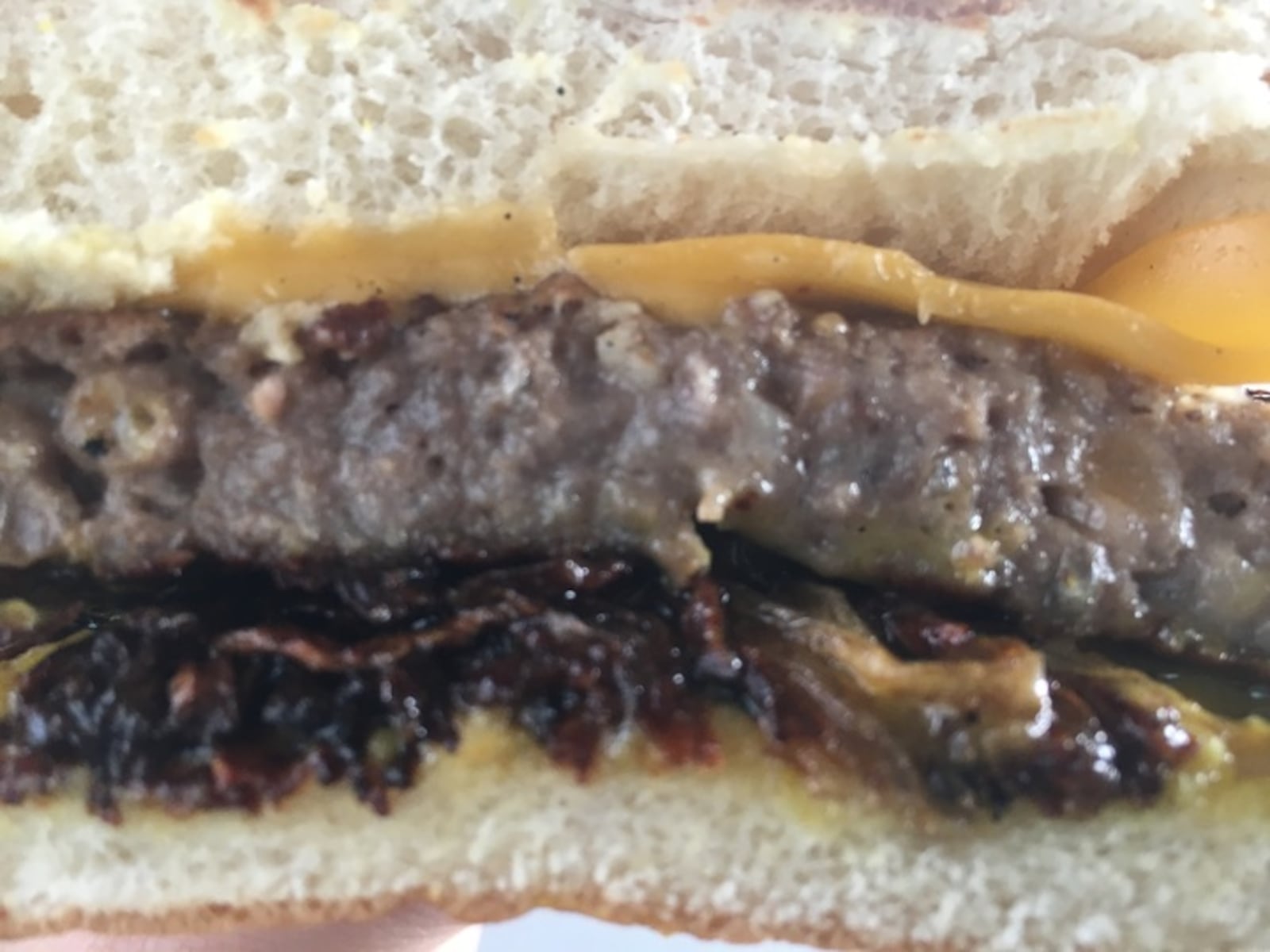 A six-ounce patty with bacon in the grinde is complemented with deep-fried onions, special sauce and American cheese.