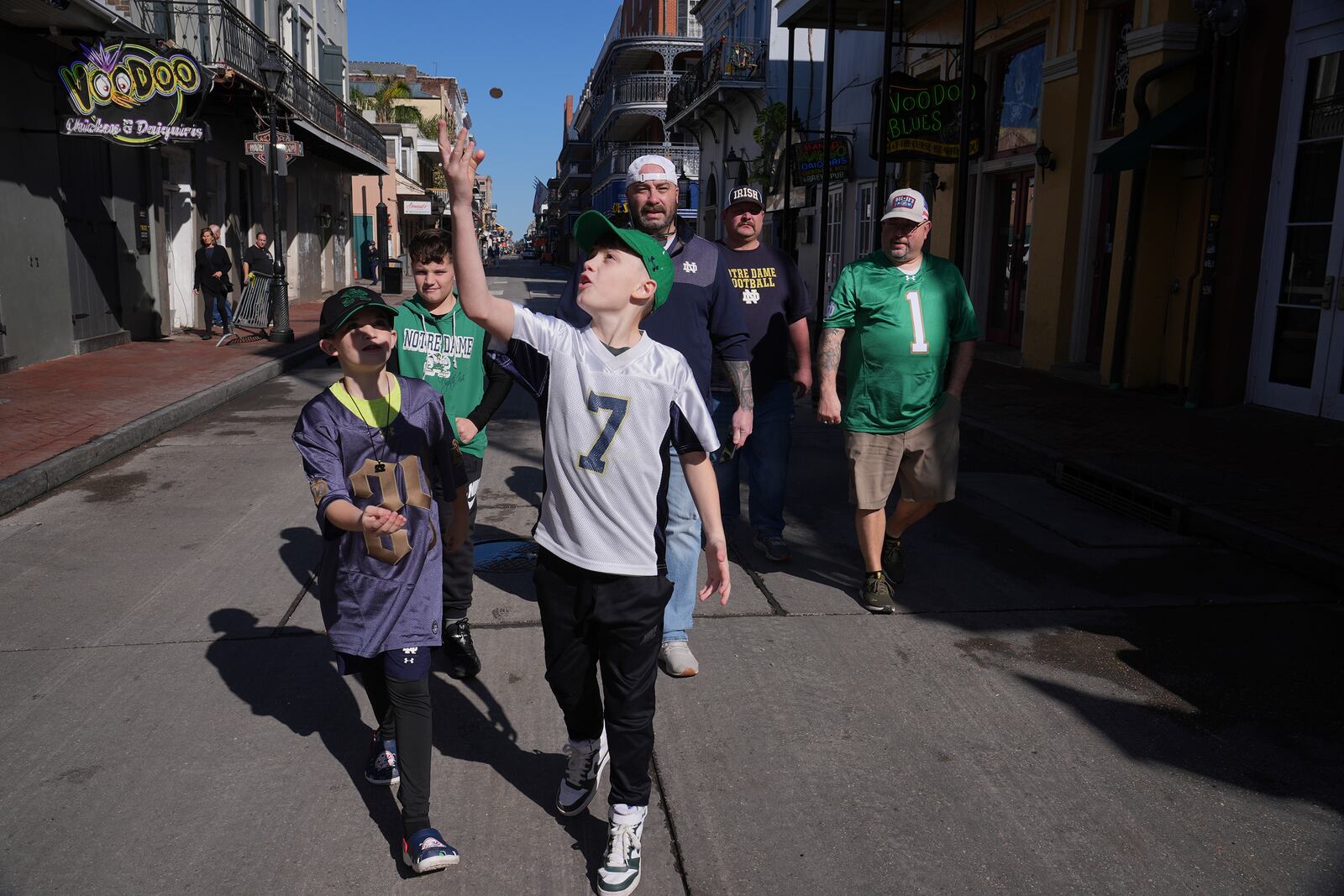 Cory Hunter flips a coin on Bourbon Street, Thursday, Jan. 2, 2025 in New Orleans. (AP Photo/George Walker IV)