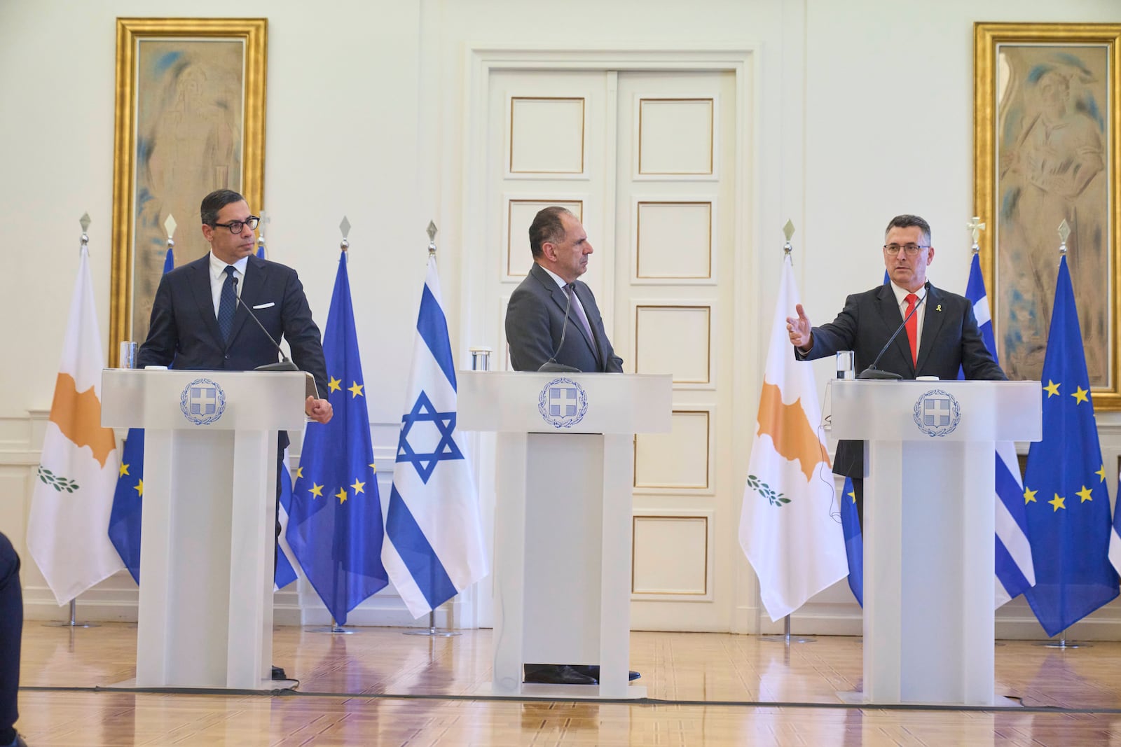 Israel's Foreign Minister Gideon Sa'ar, right, answers a question next to Greece' Foreign minister Giorgos Gerapetritis, centre, and Cyprus' Foreign Minister Constantinos Kombos, during a news conference and after trilateral meeting on energy cooperation in Athens, Thursday, March 13, 2025. (AP Photo/Petros Giannakouris)