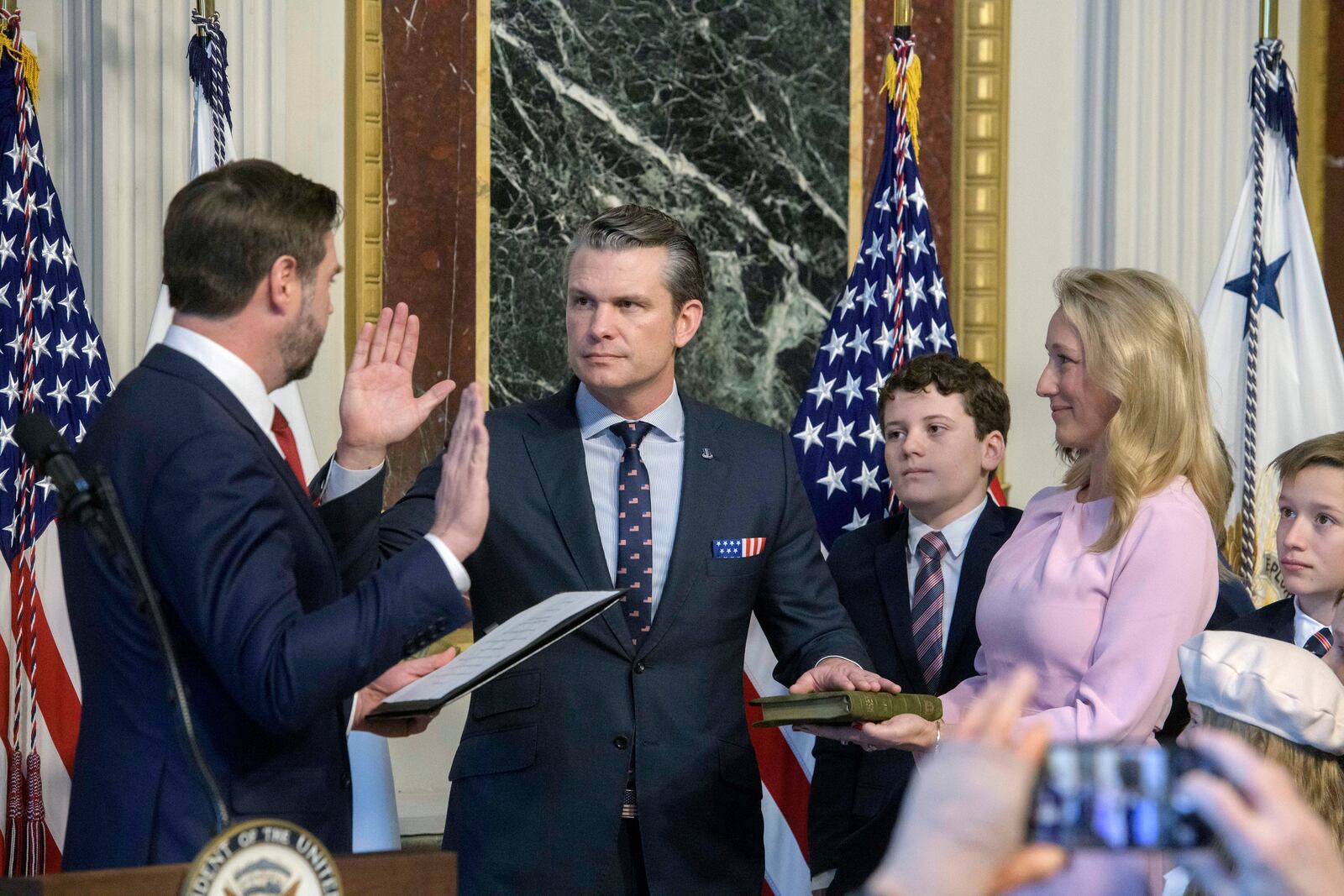 Vice President JD Vance, from left, swears in Pete Hegseth to be Secretary of Defense as his wife Jennifer Rauchet holds the Bible and Hegseth's children watch in the Indian Treaty Room of the Eisenhower Executive Office Building on the White House campus in Washington, Saturday, Jan. 25, 2025. (AP Photo/Rod Lamkey, Jr.)