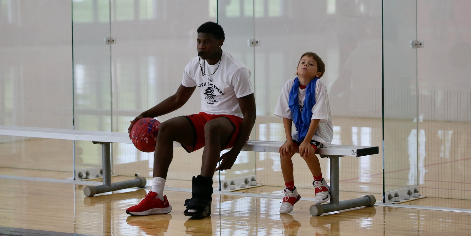 Malachi Smith sits next to a kid at the Smith Camp on Saturday, July 16, 2023, at the UD Rec Plex. David Jablonski/Staff