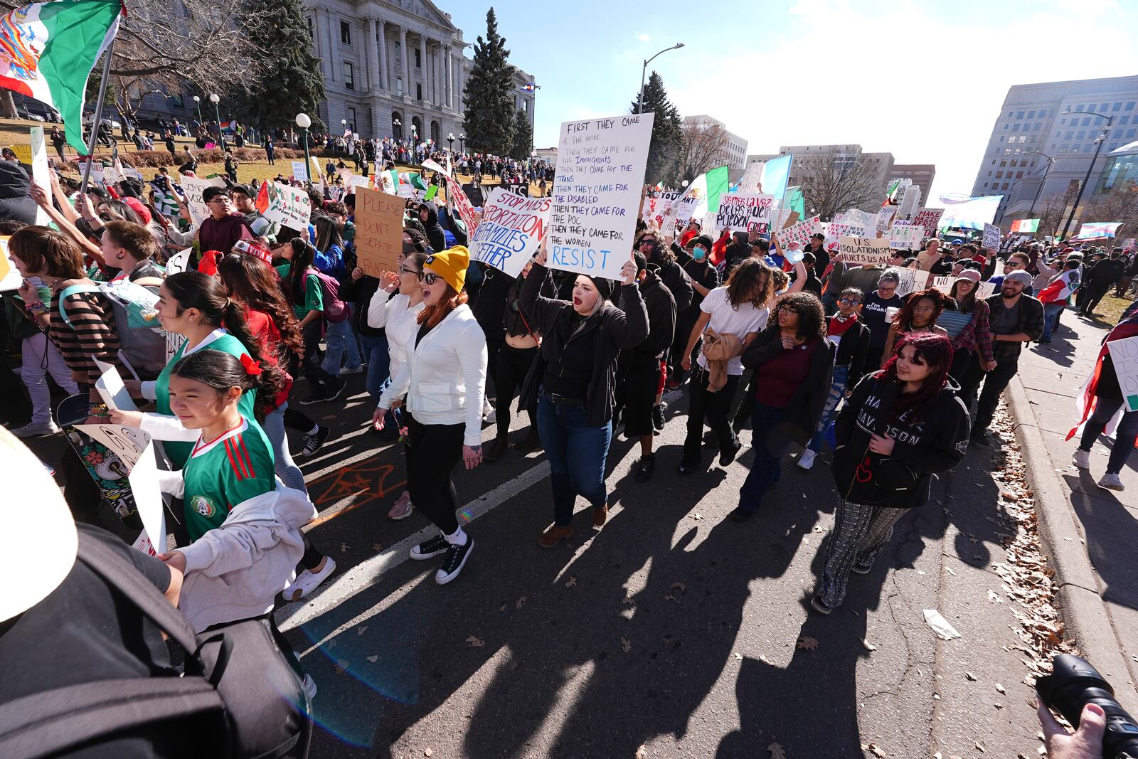 Participants walk down Lincoln Street during a political protest outside the State Capitol Wednesday, Feb. 5, 2025, in Denver. (AP Photo/David Zalubowski)