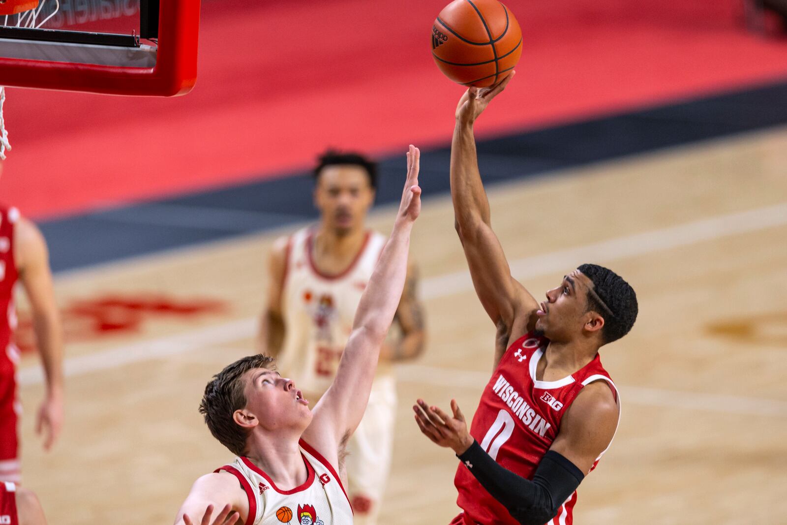 Wisconsin guard D'Mitrik Trice (0) shoots over Nebraska guard Thorir Thorbjarnarson during the second half of an NCAA college basketball game Wednesday, Feb. 10, 2021, in Lincoln, Neb. (AP Photo/John Peterson)