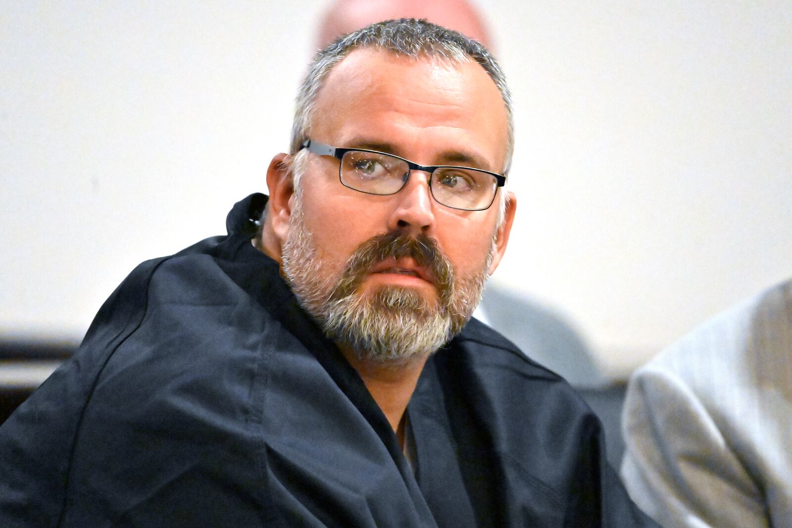 FILE - Former Letcher County Ky. Sheriff Shawn "Mickey" Stines looks over at the prosecutors during a hearing at the Morgan County Courthouse in West Liberty, Ky., Oct. 1, 2024. (AP Photo/Timothy D. Easley, File)